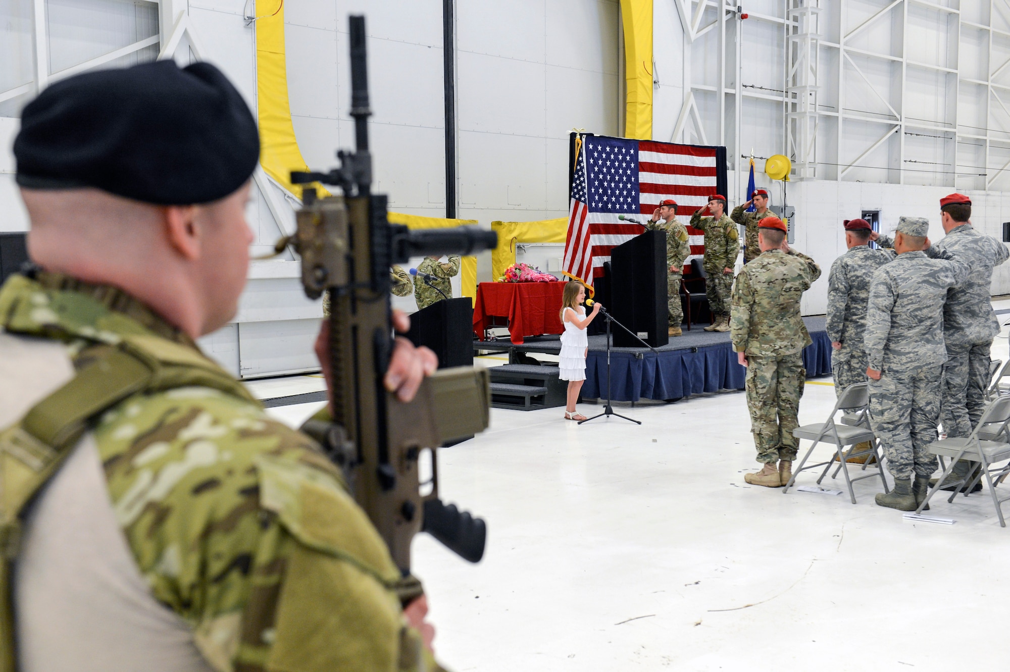 The daughter of Col. Thad Allen, outgoing 22nd Special Tactics Squadron commander, sings the National Anthem in front of members of 22nd STS and their families during a change of command ceremony, June 3, 2014, at Joint Base Lewis-McChord, Wash. The 22nd STS is responsible for training, equipping and employing combat control, tactical air control party and combat mission support personnel. (U.S. Air Force photo/Staff Sgt. Russ Jackson)