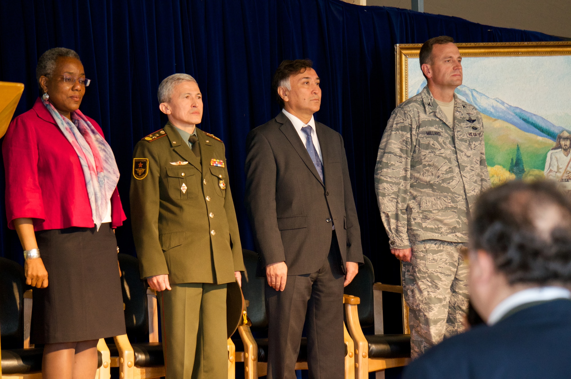The Honorable Pamela Spratlen, U.S. Ambassador to the Kyrgyz Republic, Col. Zamir Suerkulov, 1st Deputy Minister of the Kyrgyz Ministry of Defense, Mr. Erines Otorbaev, Deputy Minister of Foreign Affairs, and Col. John Millard, Director of the Transit Center at Manas, await the beginning of the Transfer Ceremony at the Transit Center at Manas, June 3, 2013. The event signified the symbolic transfer of control of the Transit Center between the United States and Kyrgyz governments. The facility stood up 12 and a half years ago after the terrorist attacks in America on Sept. 11, 2001. The center was the premier transportation and logistics hub supporting combat operations for Operation Enduring Freedom.  (Photo courtesy of Capt. Cory O'Brien)