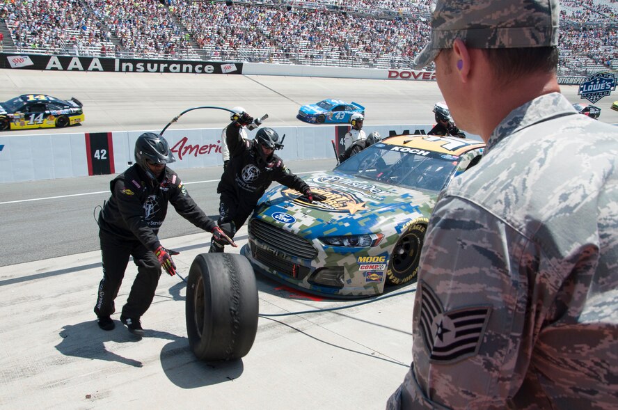 Tech. Sgt. Joshua Jenson, 436th Aircraft Maintenance Squadron C-5M Super Galaxy crew chief, prepares to receive a tire from the pit crew of Blake Koch, driver of the No. 32 C & J Energy Ford, at the FedEx 400 June 1, 2014 at Dover International Speedway in Dover, Del. Jenson was serving as an honorary pit crew member for Koch. (U.S. Air Force photo/Senior Airman Jared Duhon) 