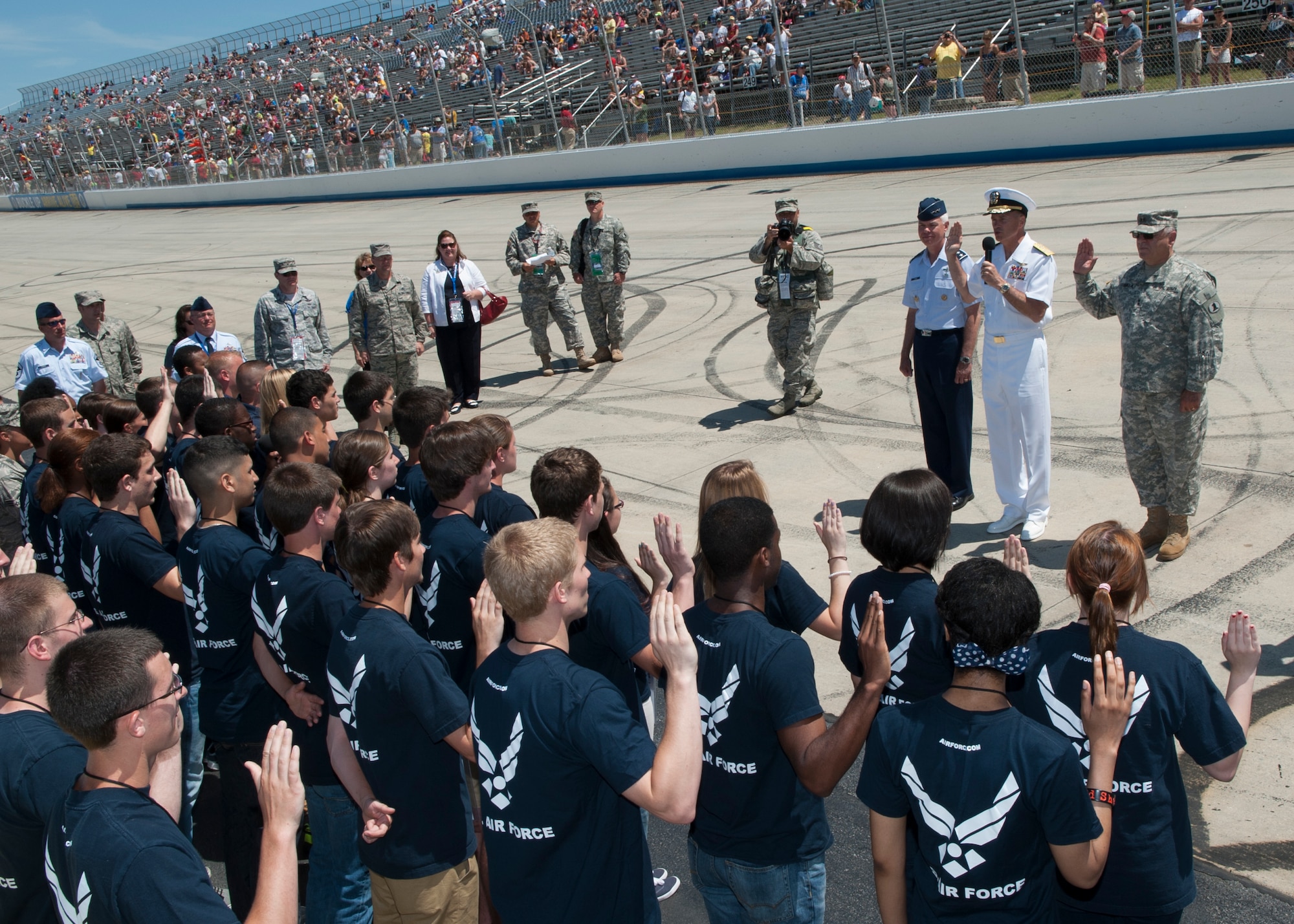 From left to right,Lt . Gen. Charles R. Davis, Office of the Assistant Secretary of the Air Force for Acquisition military deputy, Adm. James A. Winnefeld, Jr., Vice Chairman of the Joint Chiefs of Staff, and Maj. Gen. Francis D. Vavala, Delaware Army National Guard adjunct general, administer the oath of enlistment to more than 40 enlistees before the start of the NASCAR Sprint Cup Series FedEx 400 benefiting Autism Speaks June 1, 2014, at Dover International Speedway in Dover, Del. (U.S. Air Force photo/Airman 1st Class Zachary Cacicia)
