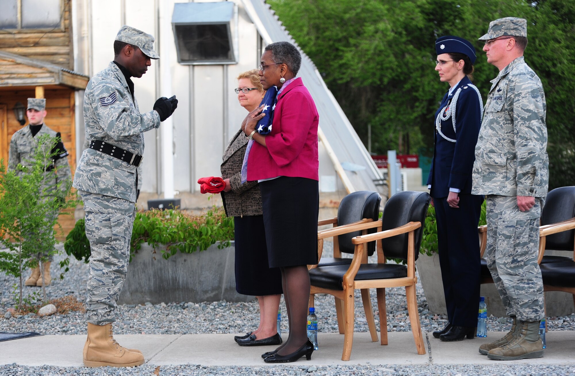 The Honorable Pamela Spratlen, U.S. Ambassador to the Kyrgyz Republic, receives the American flag after a retreat held at Transit Center at Manas, Kyrgyzstan, June 3, 2014.  The retreat was part of the 376th Air Expeditionary Wing inactivation ceremony which involved comments from the ambassador and the 376th AEW commander, Col. John Millard, as well as sheathing the squadron, group, and wing guidons.  (U.S. Air Force Photo/Lt. Col. Max Despain)