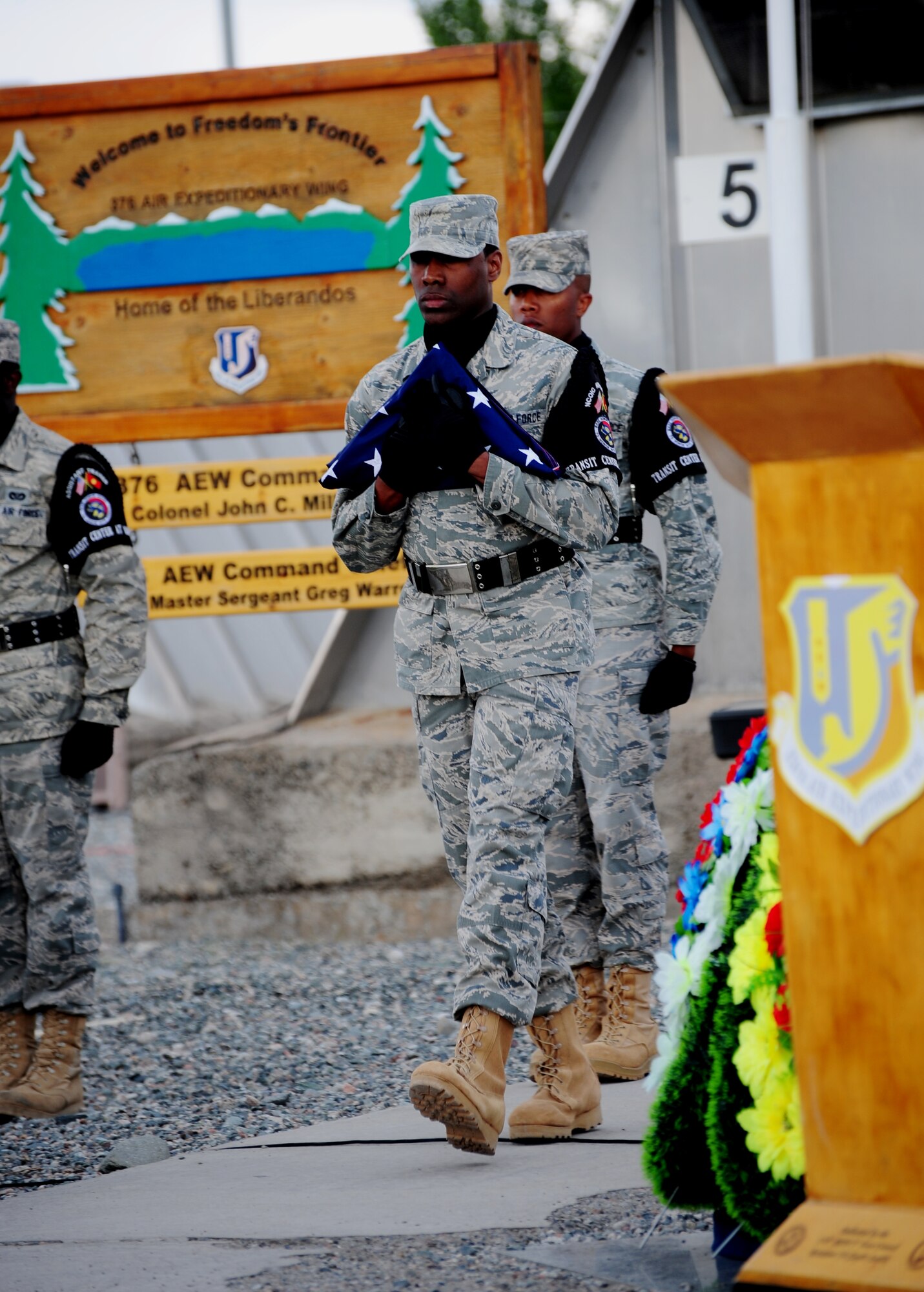 An Honor Guard Airman carries the American flag following a retreat during the 376th Air Expeditionary Wing inactivation ceremony at Transit Center at Manas, Kyrgyzstan, June 3, 2014. During its more than 12-year tenure, the wing performed four critical missions including air refueling, onward movement, airlift and humanitarian assistance. (U.S. Air Force Photo/Lt. Col. Max Despain)  