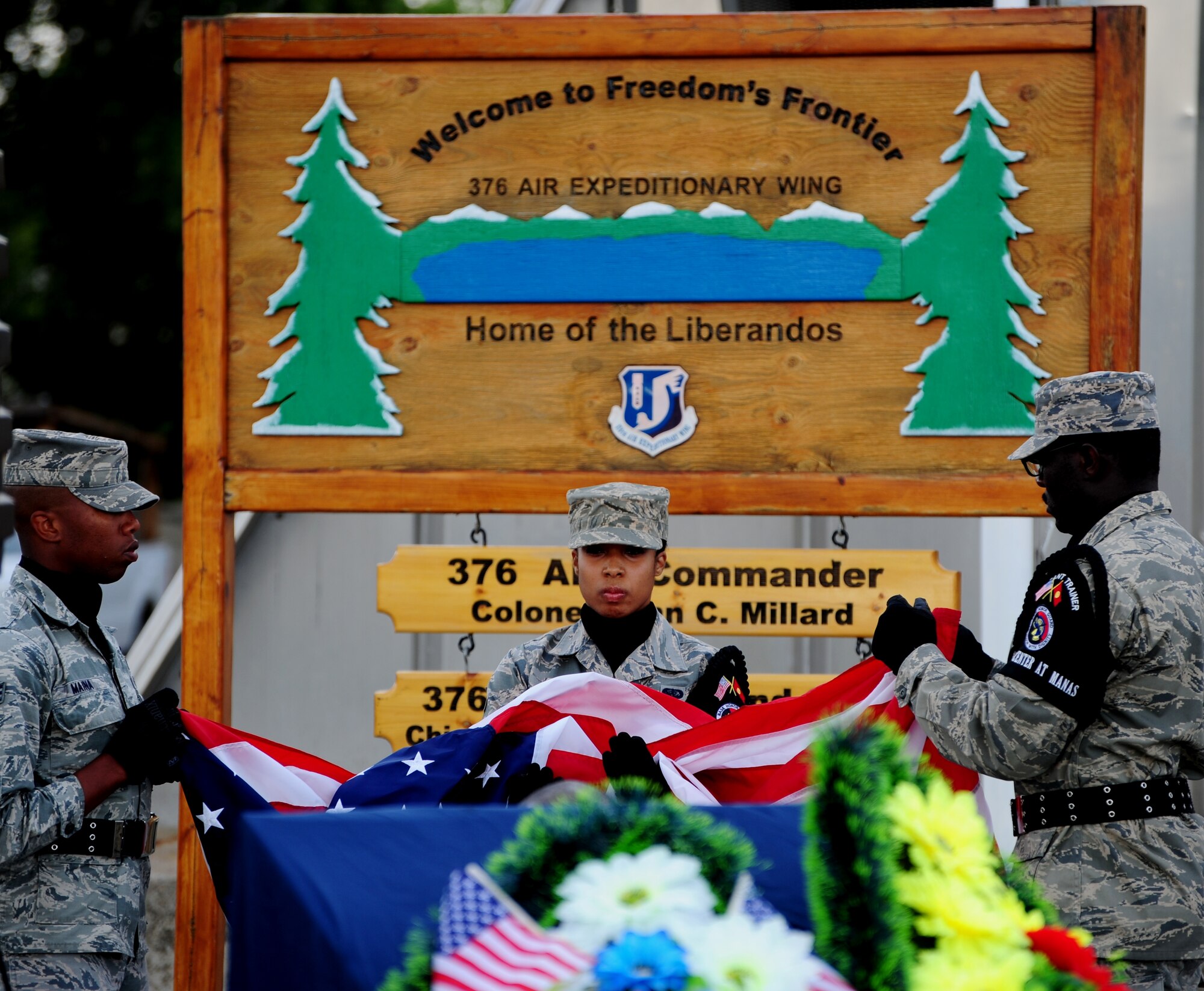 Honor Guard Airmen fold the American flag during a retreat during the 376th Air Expeditionary Wing inactivation ceremony at Transit Center at Manas, Kyrgyzstan, June 3, 2014. The ceremony marked the end of a 12-and-a-half-year era. Since 2001, coalition personnel and aircraft from 10 countries have operated out of the Transit Center at Manas to support operations in Afghanistan. (U.S. Air Force Photo/Lt. Col. Max Despain) 