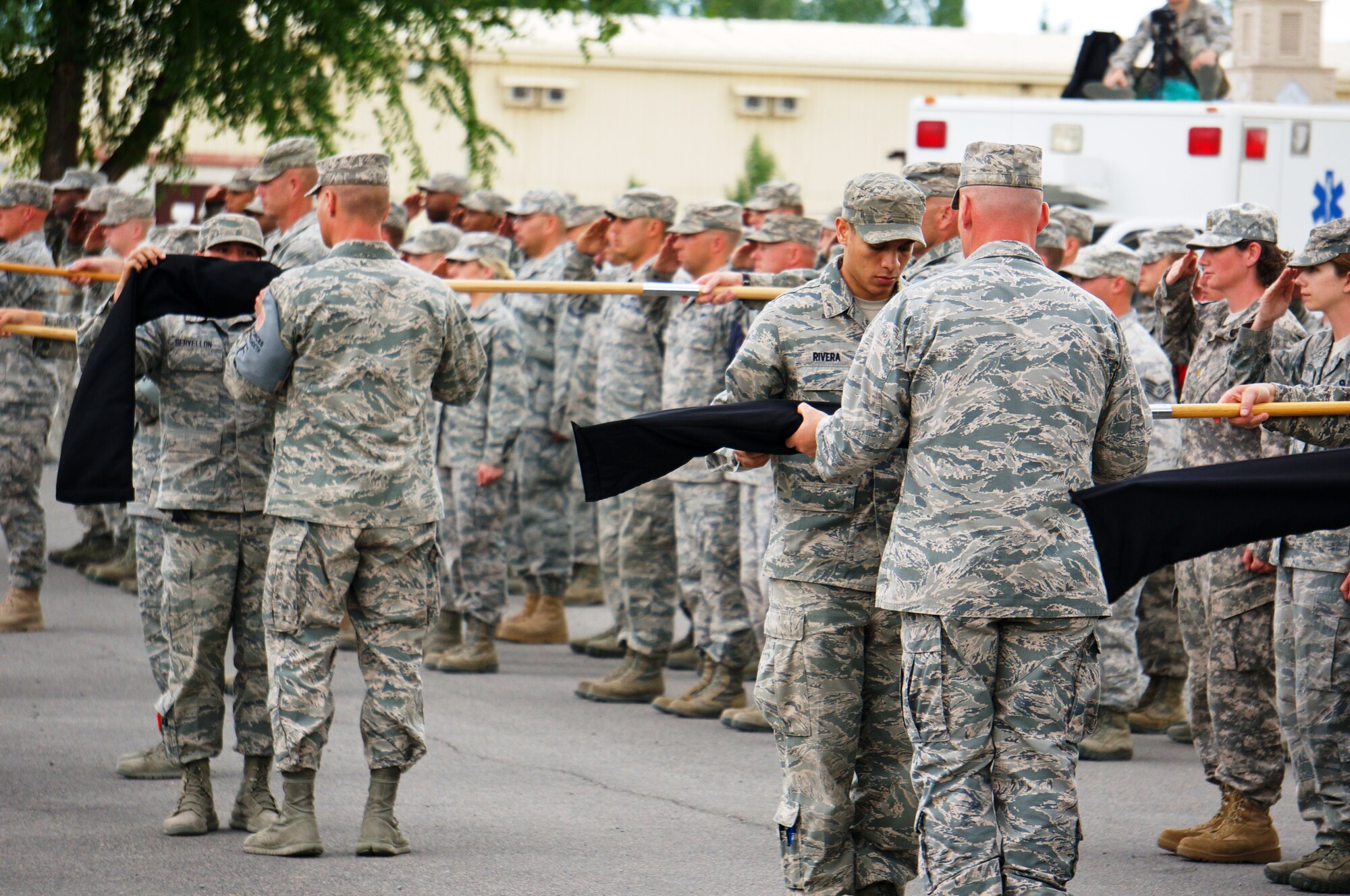 Airmen sheath squadron guidons as part of the 376th Air Expeditionary Wing inactivation ceremony at Transit Center at Manas, Kyrgyzstan, June 3, 2014. The Wing's roots date from the activation of the 376th Bombardment Group (Heavy) during World War II. The 376th AEW took the name "Liberandos" from the B-24 Liberator bombers it flew during this conflict. (Photo Courtesy of Capt. Cory O'Brien)