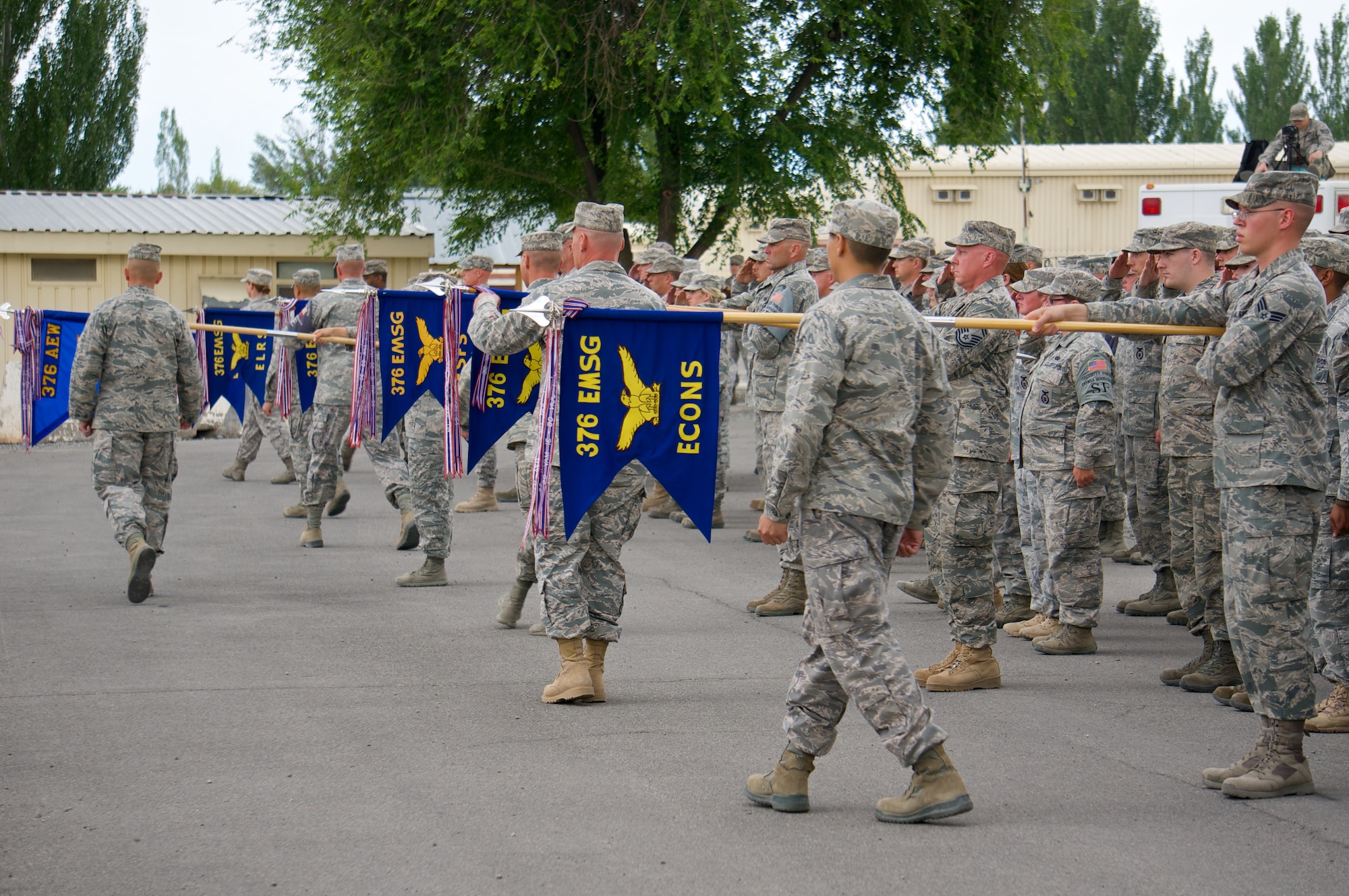 Airmen from the 376th Air Expeditionary Wing prepare to sheath squadron and group guidons as part of the wing's inactivation ceremony at Transit Center at Manas, Kyrgyzstan, June 3, 2014. During its 12-and-a-half years as a key regional transportation hub, the Transit Center served as a thoroughfare for 5.3 million coalition personnel, which accounts for approximately 98 percent of all coalition forces who moved in and out of Afghanistan during this period. (Photo Courtesy of Capt. Cory O'Brien)