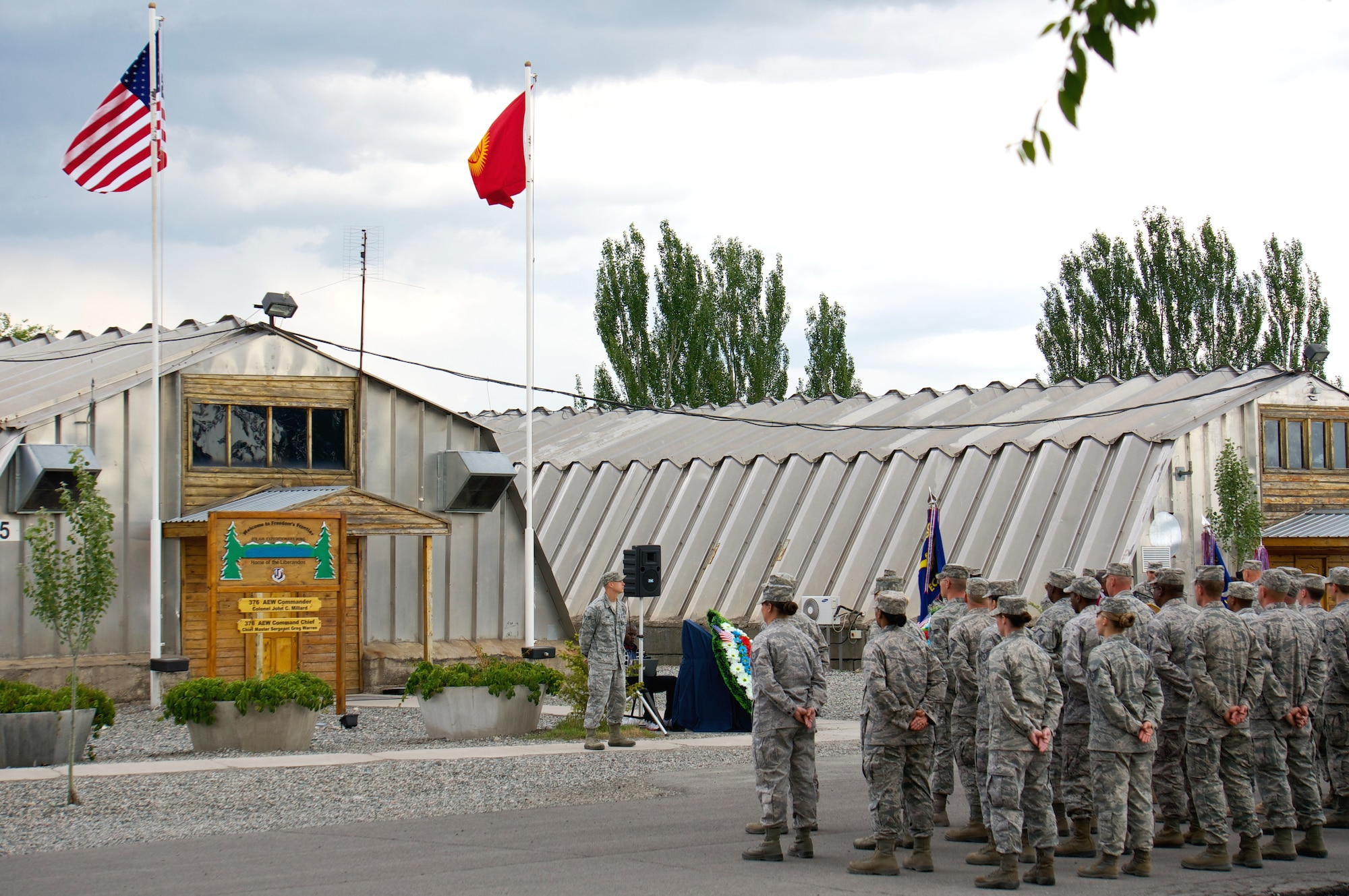 Airmen from the 376th Expeditionary Contracting Squadron and 376th Air Expeditionary Wing Staff Agencies await the beginning of the wing's inactivation ceremony at Transit Center at Manas, Kyrgyzstan, June 3, 2014. During its more than 12-year tenure, the wing performed four critical missions including air refueling, onward movement, airlift and humanitarian assistance. (Photo Courtesy of Capt. Cory O'Brien) 