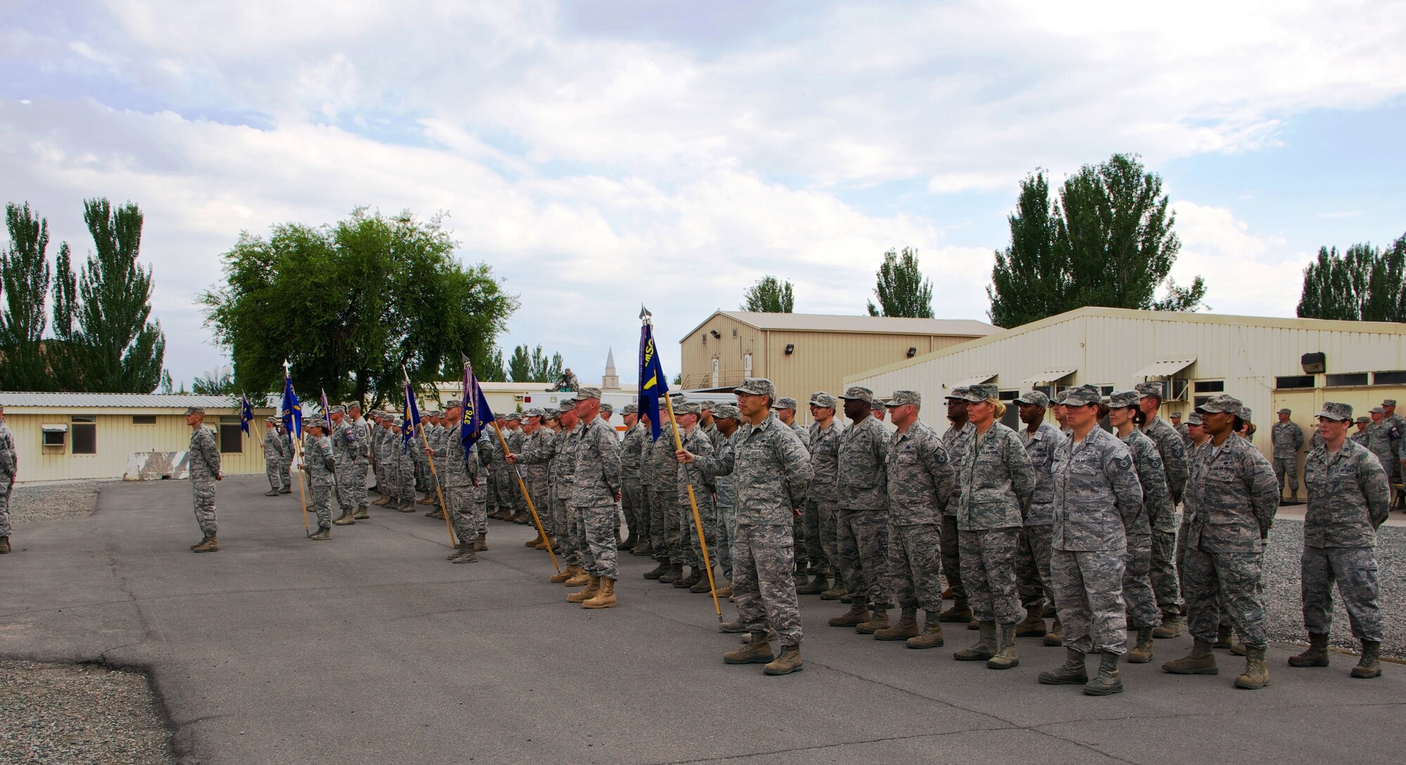 Airmen stand at parade rest during the 376th Air Expeditionary Wing inactivation ceremony at Transit Center at Manas, Kyrgyzstan, June 3, 2014. For more than 12 years, the American military has operated out of Transit Center at Manas. It served as the premier transportation and logistics hub supporting operations in Afghanistan. (Courtesy  Photo/Capt. Cory O'Brien) 