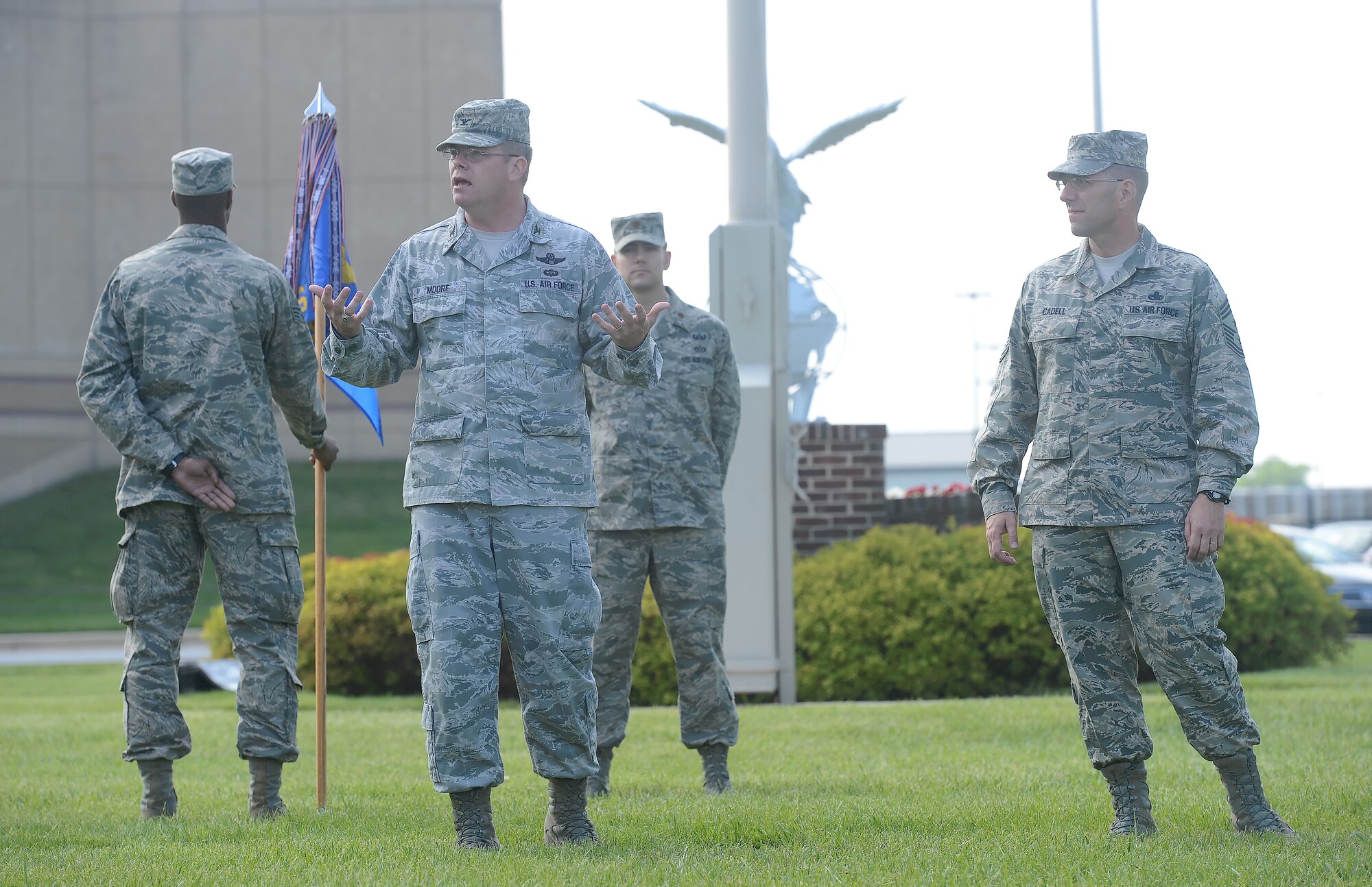 Col. Richard G. Moore, Jr., 436th Airlift Wing commander, speaks to Airmen immediately following a formal retreat ceremony conducted by the 436th Civil Engineer Squadron May 30, 2014, at Dover Air Force Base, Del. Chief Master Sgt. Stanley C. Cadell (right), command chief, listens and stands-by to provide comments to the gathers troops, as well. (U.S. Air Force photo/Greg L. Davis) 