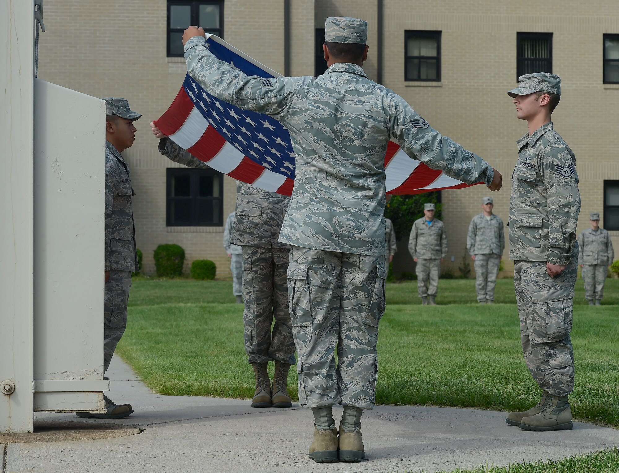Members of the 436th Civil Engineer Squadron prepare to fold the American flag during a formal retreat ceremony May 30, 2014, at Dover Air Force Base, Del. The retreat ceremony duties are rotated between units and tenant units on the base throughout the year. (U.S. Air Force photo/Greg L. Davis) 