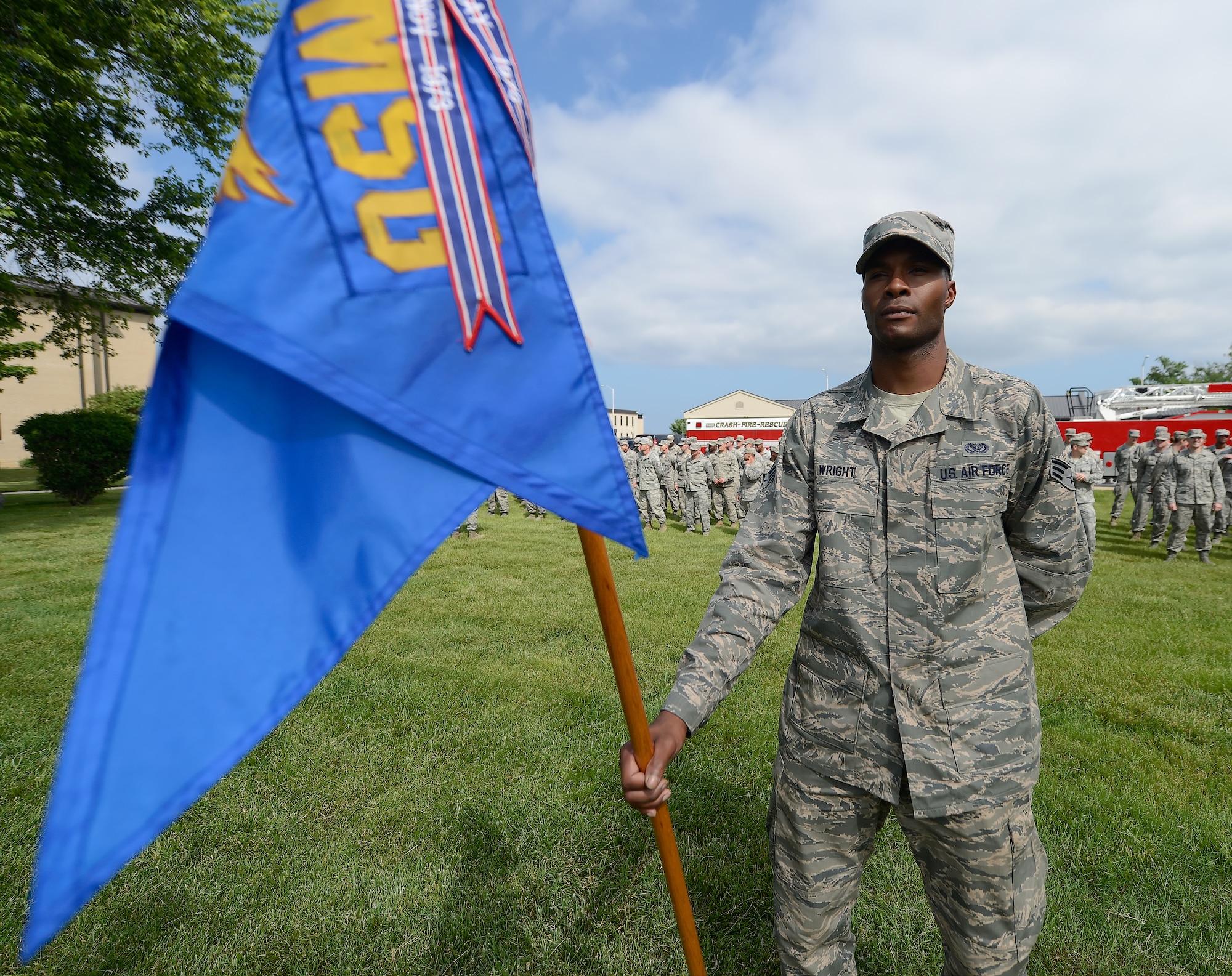 Senior Airman Andrew Wright, 436th Civil Engineer Squadron electrical shop, stands at parade rest while holding the unit guidon prior to a formal retreat ceremony by members of the his unit May 30, 2014, at Dover Air Force Base, Del. The commander of the 436th Airlift Wing, Col. Richard G. Moore, Jr. and the command chief, Chief Master Sgt. Stanley C. Cadell, also attended the ceremony. (U.S. Air Force photo/Greg L. Davis) 