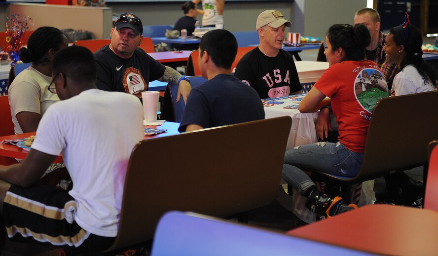 Airmen from the First Four Airmen Association speak with Patrick McDonald, a Paralympian curler, and Robi Powers, American 300 host, during the American 300 Skate-A-Thon at a skating rink in Bossier City, La., June 2, 2014. McDonald joined the American 300 tour to speak with service men and women about his experiences and theirs while in the military. (U.S. Air Force photo/Senior Airman Benjamin Gonsier)