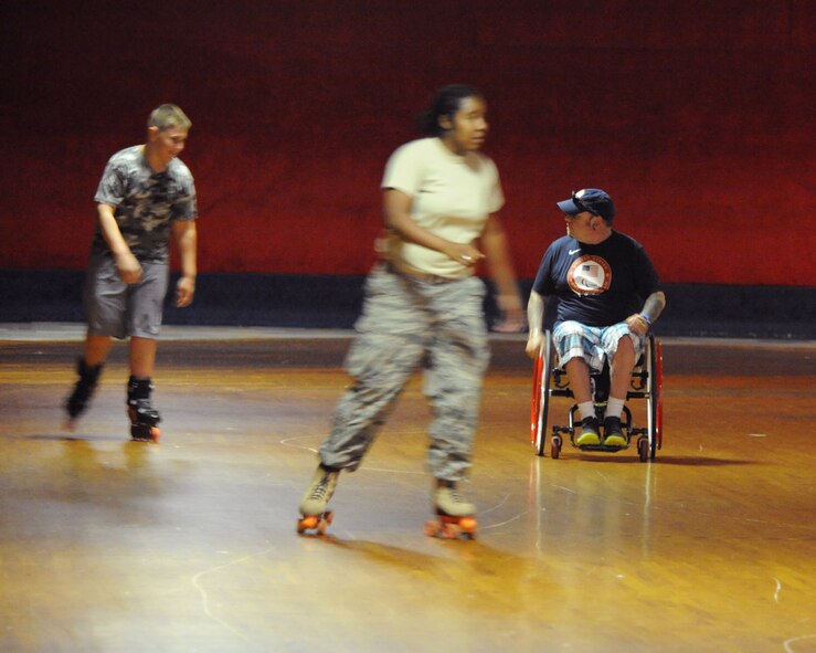 Patrick McDonald, a Paralympian curler, skates with Team Barksdale personnel during the American 300 Skate-A-Thon at a skating rink in Bossier City, La., June 2, 2014. McDonald is a U.S. Army veteran who lost the use of his legs after an accident while stationed in Korea. (U.S. Air Force photo/Senior Airman Benjamin Gonsier)