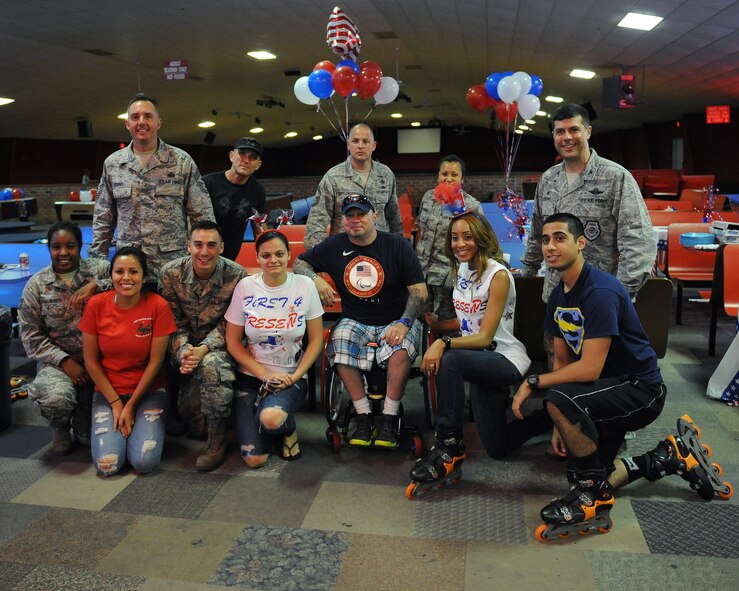 Team Barksdale personnel including Chief Master Sgt. Curtis Storms, 2nd Bomb Wing command chief, far left, and Col. Andrew Gebara, 2nd BW commander, far right, pose for a photo with Paralympian curler Patrick McDonald during the American 300 Skate-A-Thon at a skating rink in Bossier City, La., June 2, 2014. McDonald, a U.S. Army veteran, visited Barksdale to speak with military personnel and share his experiences in and out of the service. (U.S. Air Force photo/Senior Airman Benjamin Gonsier)