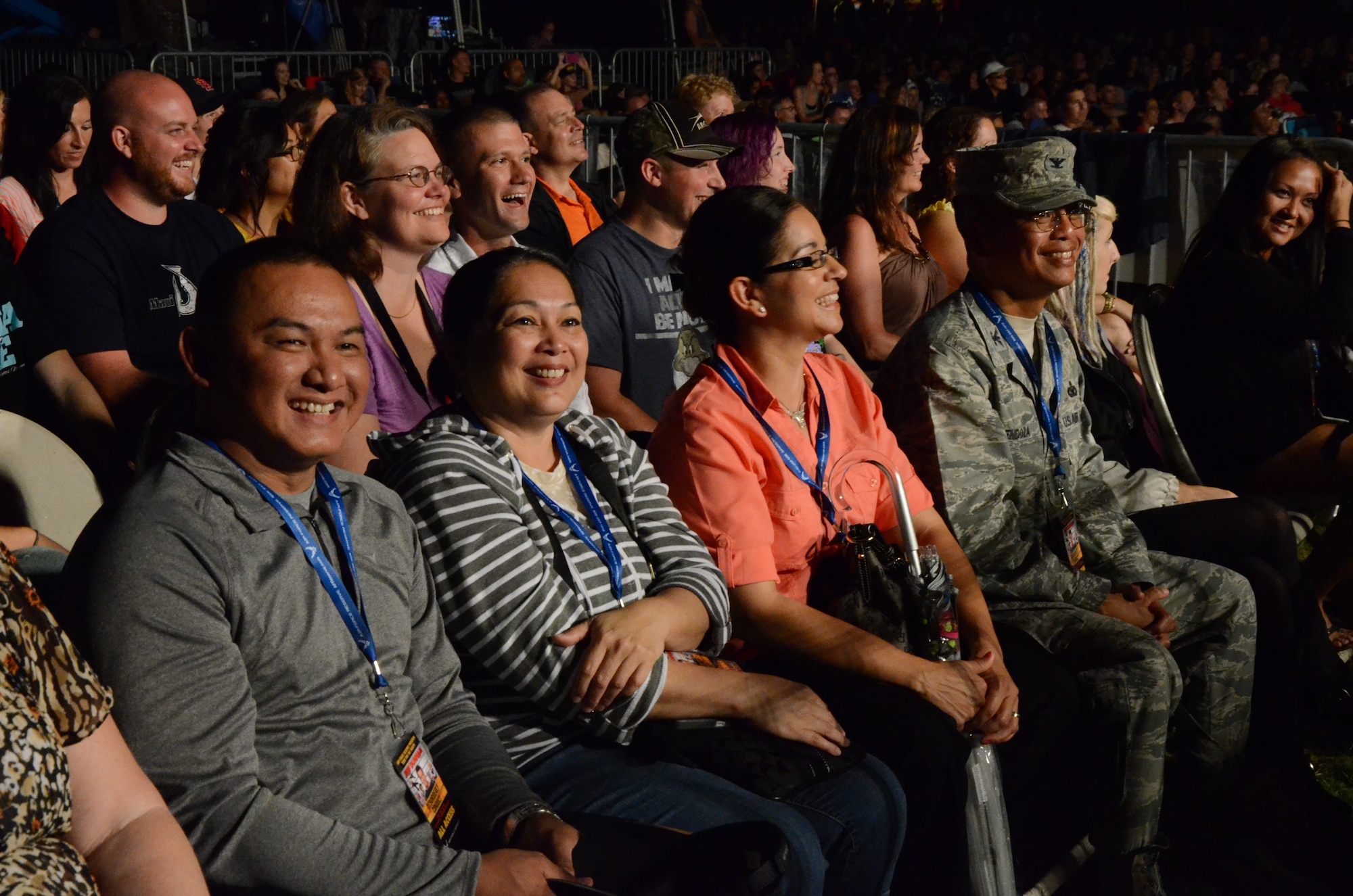 From left, Tech. Sgt. Paul Diaz, an air transportation specialist with the 44th Aerial Port Squadron, 624th Regional Support Group, Andersen Air Force Base, Guam, sits with two family members, and Col. Maynard "Max" Mendoza, far right, commander of the 624th Regional Support Group, Joint Base Pearl Harbor-Hickam, Hawaii, at an Air Force Reserve Command-sponsored Memorial Day weekend show held at Ward Field, Naval Station Pearl Harbor, Joint Base Pearl Harbor-Hickam, Hawaii, May 24, 2014. Comedian Jeff Dunham entertained the 8,500-strong crowd for an hour and a half. (U.S. Air Force photo by Tech. Sgt. Phyllis Keith)