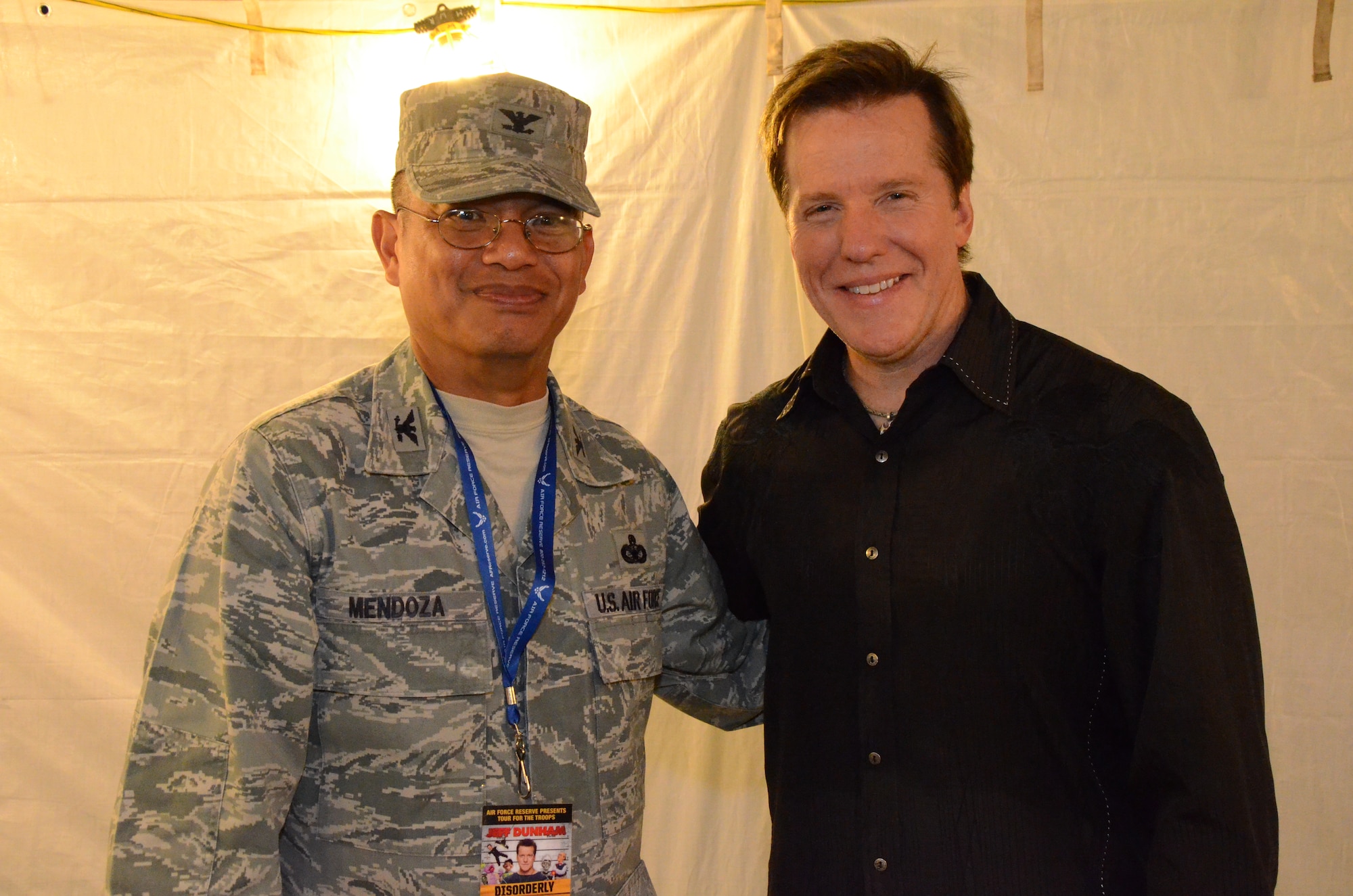 Col. Maynard "Max" Mendoza, left, commander of the 624th Regional Support Group, Joint Base Pearl Harbor-Hickam, Hawaii, poses for a photograph with comedian Jeff Dunham, right, during a post-show meet-and-greet, at an Air Force Reserve Command-sponsored Memorial Day weekend show held at Ward Field, Naval Station Pearl Harbor, Joint Base Pearl Harbor-Hickam, Hawaii, May 24, 2014. (U.S. Air Force photo by Tech. Sgt. Phyllis Keith)
