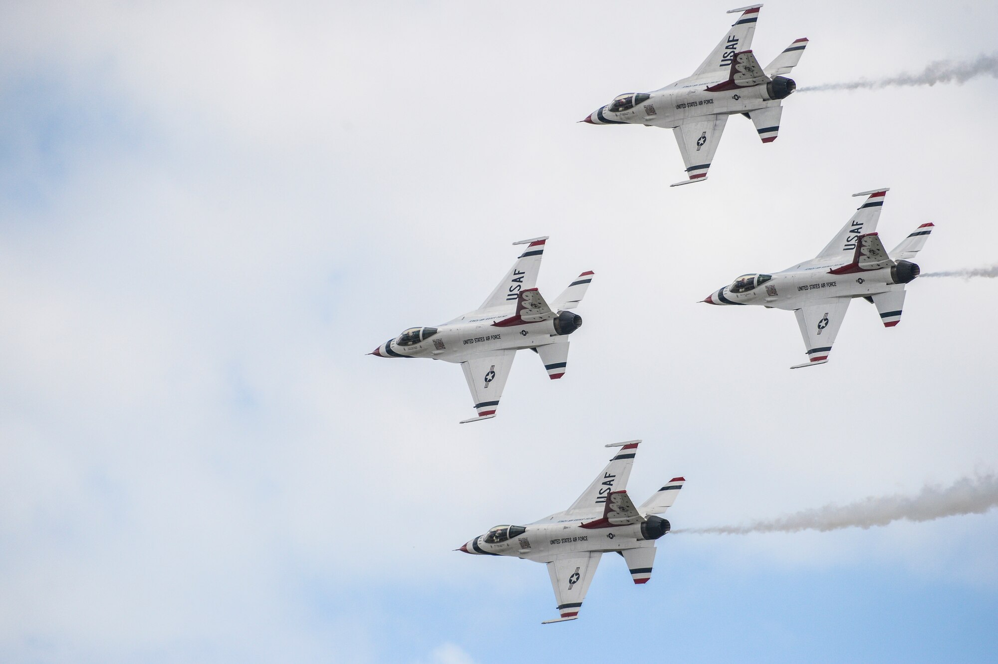 The U.S. Air Force Thunderbirds aerial demonstration team fly their F-16C Fighting Falcons in the diamond formation June 1, 2014, in the skies over Fairchild Air Force Base, Wash., during the base's SkyFest 2014 air show and open house. In support of the event, a C-17 Globemaster III and its crew from Joint Base Lewis-McChord, Wash., transported the demonstration team's support personnel and equipment from Colorado Springs, Colo., to the event at Fairchild. (U.S. Air Force photo/Tech. Sgt. Sean Tobin)