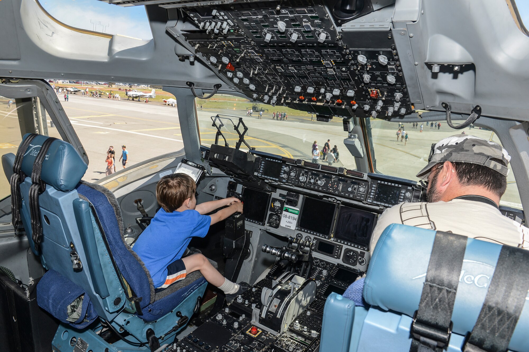 A child struggles to move the control stick on a C-17 Globemaster III static display May 31, 2014, while attending SkyFest 2014 at Fairchild Air Force Base, Wash. SkyFest is Fairchild's air show and open house and this year's two-day event hosted approximately 210,000 visitors to the base. (U.S. Air Force photo/Tech. Sgt. Sean Tobin)