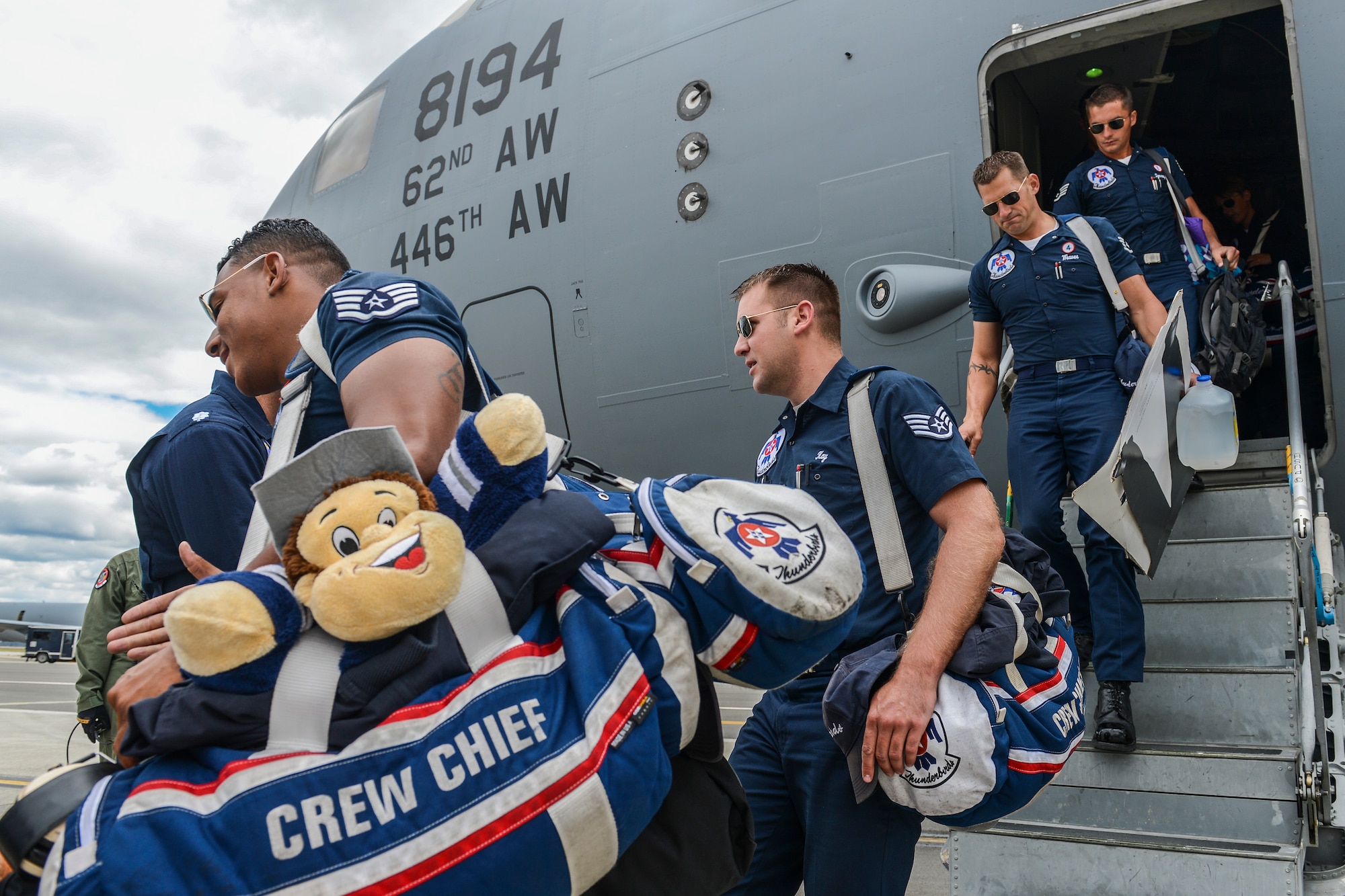 Members of the U.S. Air Force Thunderbirds support team are greeted by the Thunderbirds pilots May 29, 2014, as they exit a McChord C-17 Globemaster III at Fairchild Air Force Base, Wash. The C-17 transported 51 members of the demonstration team and 50,000 pounds of their equipment from Colorado Springs, Colo., to Fairchild to participate in Fairchild's SkyFest 2014. (U.S. Air Force photo/Tech. Sgt. Sean Tobin)