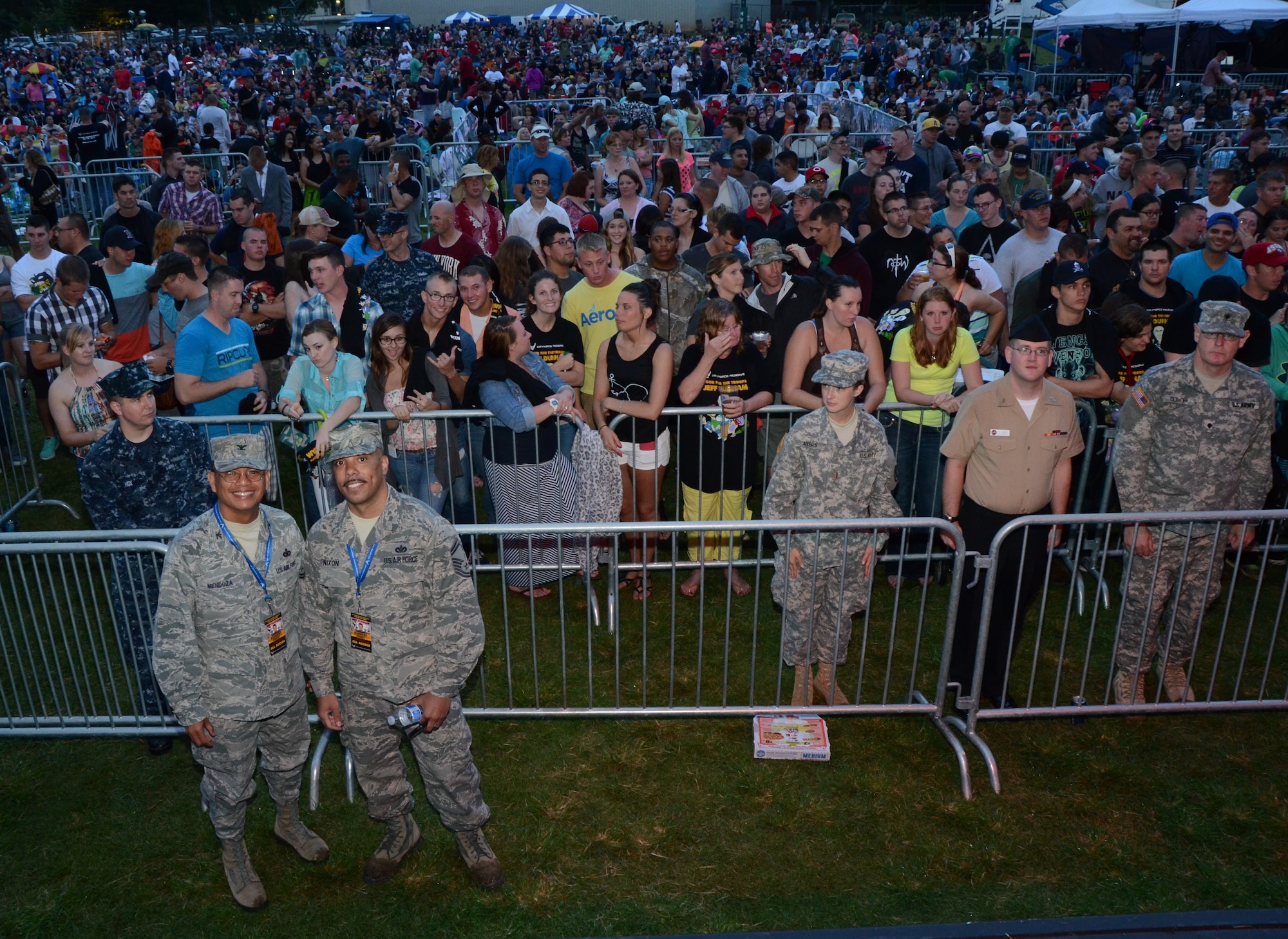 Col. Maynard "Max" Mendoza, left, commander of the 624th Regional Support Group, Joint Base Pearl Harbor-Hickam, Hawaii, poses for a photo with Senior Master Sgt. Carl Nixon, right, flight chief for Air Force Reserve Command Recruiting Services Pacific Air Forces, Joint Base Pearl Harbor-Hickam, Hawaii, in front of a crowd at an AFRC-sponsored Memorial Day weekend event held at Ward Field, Naval Station Pearl Harbor, Joint Base Pearl Harbor-Hickam, Hawaii, May 24, 2014. (U.S. Air Force photo by Tech. Sgt. Phyllis Keith)