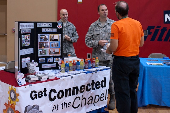 (left to right) 2nd Lt. Daniel Stark, 99th Air Base Wing chaplain candidate, and Staff Sgt. David Day, 99th ABW chaplains assistant, discuss opportunities provided by the chapel with Gregory Valiquette, 88th Test and Evaluation Squadron administrative assistant, during a Health Fair May 30, 2014 at Nellis Air Force Base, Nev.  The chapel provides opportunities for Airmen and their families to strengthen their overall social, physical, mental and spiritual fitness. (U.S. Air Force photo by Senior Airman Timothy Young)