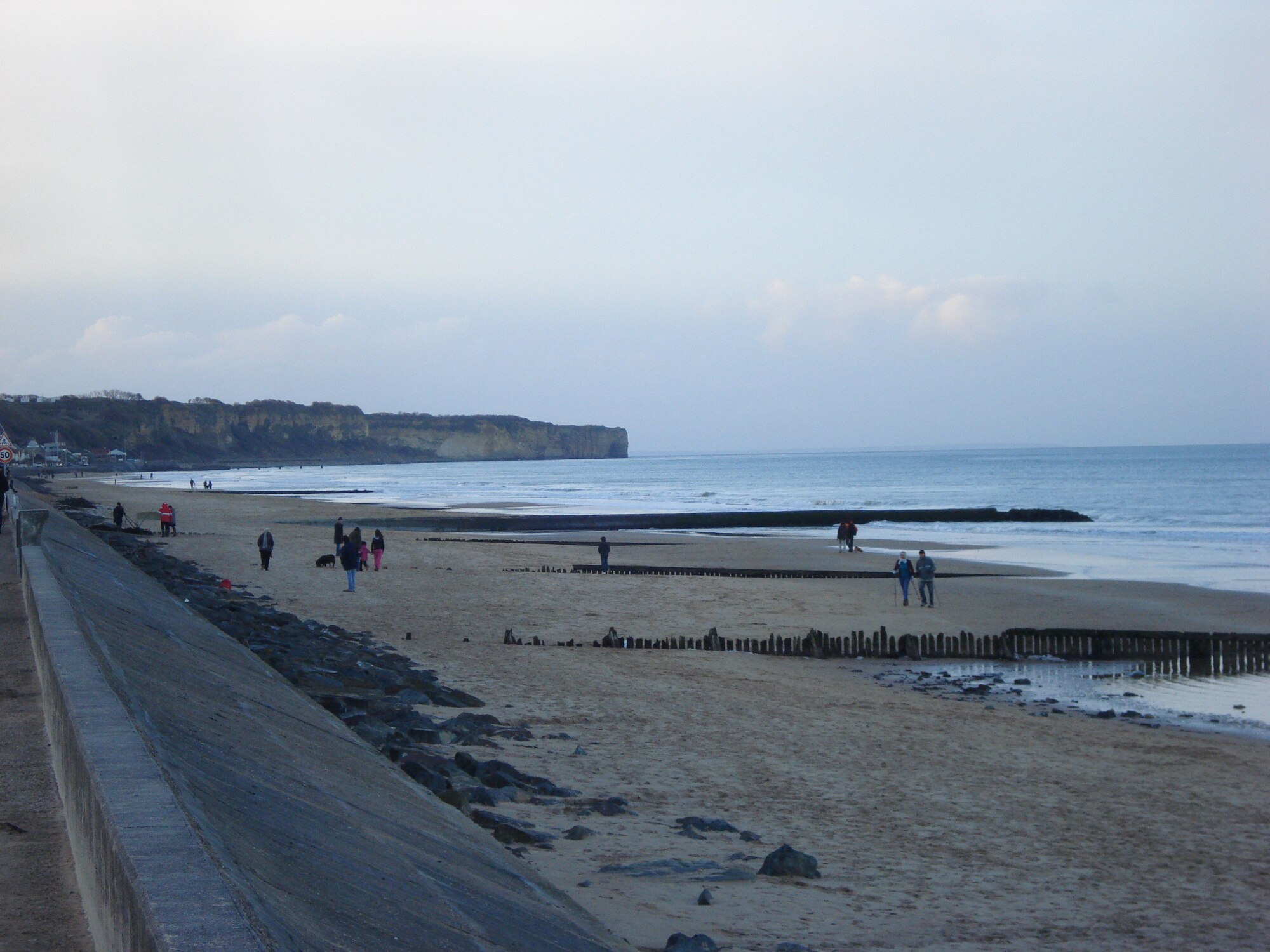 Visitors walk along the Normandy coastline, which served as the Allied forces invasion site June 6, 1944, during World War II.  The Americans invaded the Utah and Omaha Beaches while the British forces took on the Sword and Gold Beaches and the Canadian forces took on Juno Beach. (Courtesy photo/Capt. Laura Balch/Released)