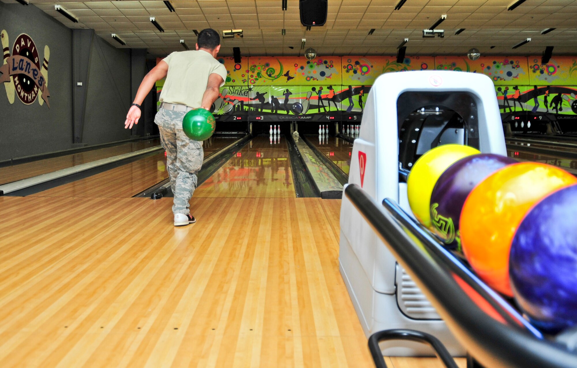 U.S. Air Force Airman Kevin Vazquez, 355th Equipment Maintenance Squadron information manager, bowls during a Social Comprehensive Airman Fitness Day event at Davis-Monthan Air Force Base, Ariz., June 2, 2014.  CAF is an Air Force-wide initiative based on improving Airman readiness by solidifying the four pillars of CAF: mental, physical, social and spiritual. (U.S. Air Force Photo by Airman 1st Class Chris Massey/Released)