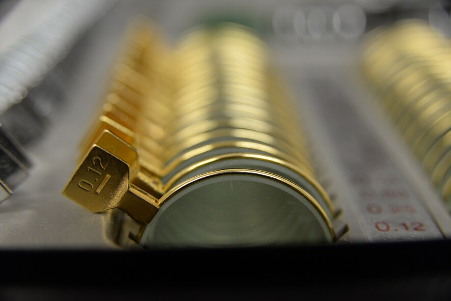 A row of optical lenses sit in a case at the optometry clinic May 29, 2014, at Shaw Air Force Base, S.C. Doctors use the lenses to verify what prescription patients will need.  (U.S. Air Force photo by Airman 1st Class Michael A. Cossaboom/Released) 
