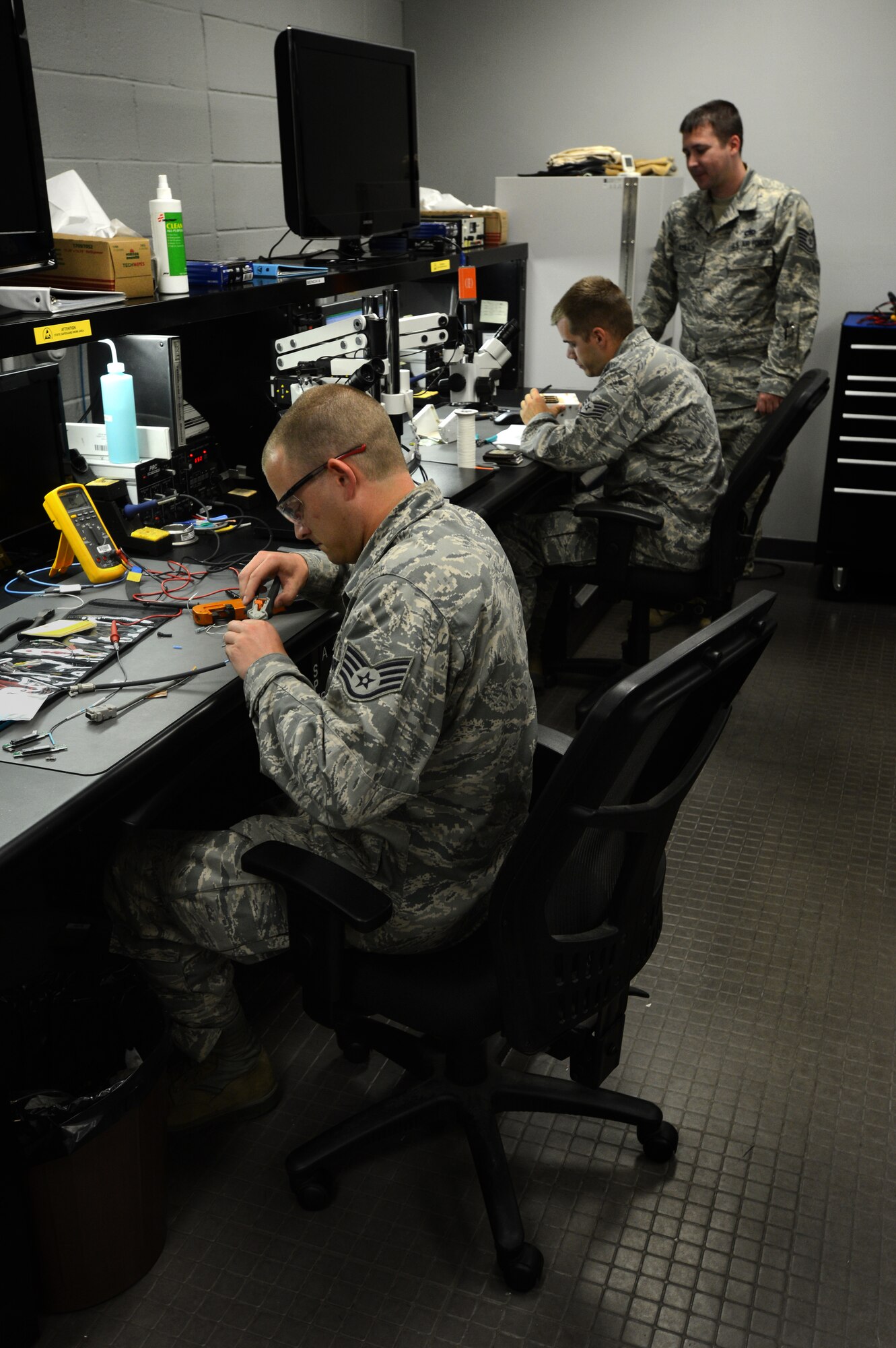 [From left] U.S. Air Force Staff Sgt. Scott Williams, Tech Sgt. Michael Kelly and Staff Sgt. Laverne Borst, 20th Maintenance Group Air Force Repair Enhancement Program technicians, determine the cause of several broken parts from around the 20th Fighter Wing at Shaw Air Force Base, S.C., May 21, 2014.  The three technician’s goal is to save the 20th FW at least $100,000 each month by fixing broken parts instead of buying new ones. (U.S. Air Force photo by Airman 1st Class Jensen Stidham/Released)