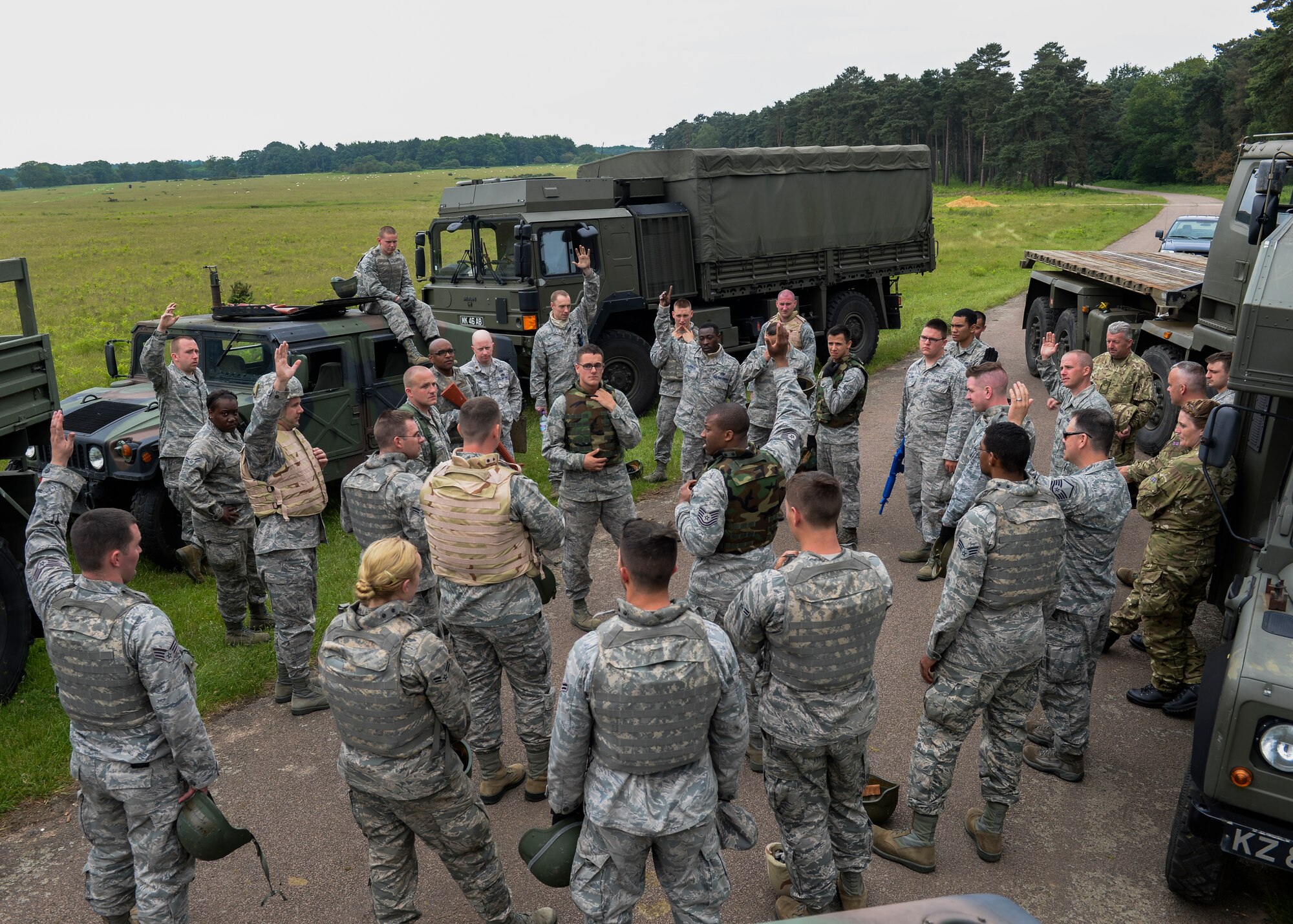 U.S. and U.K. armed forces are a briefed during Combat Operation Readiness Training at Stanford Training Area, England, May 30, 2014. The joint forces exercise between the 48th Logistics Readiness Squadron vehicle operators and the 6 Regiment Army Corps of Bury St. Edmunds helps military members train in convoy skills needed in deployed environments. (U.S. Air Force photo by Airman 1st Nigel Sandridge/Released)