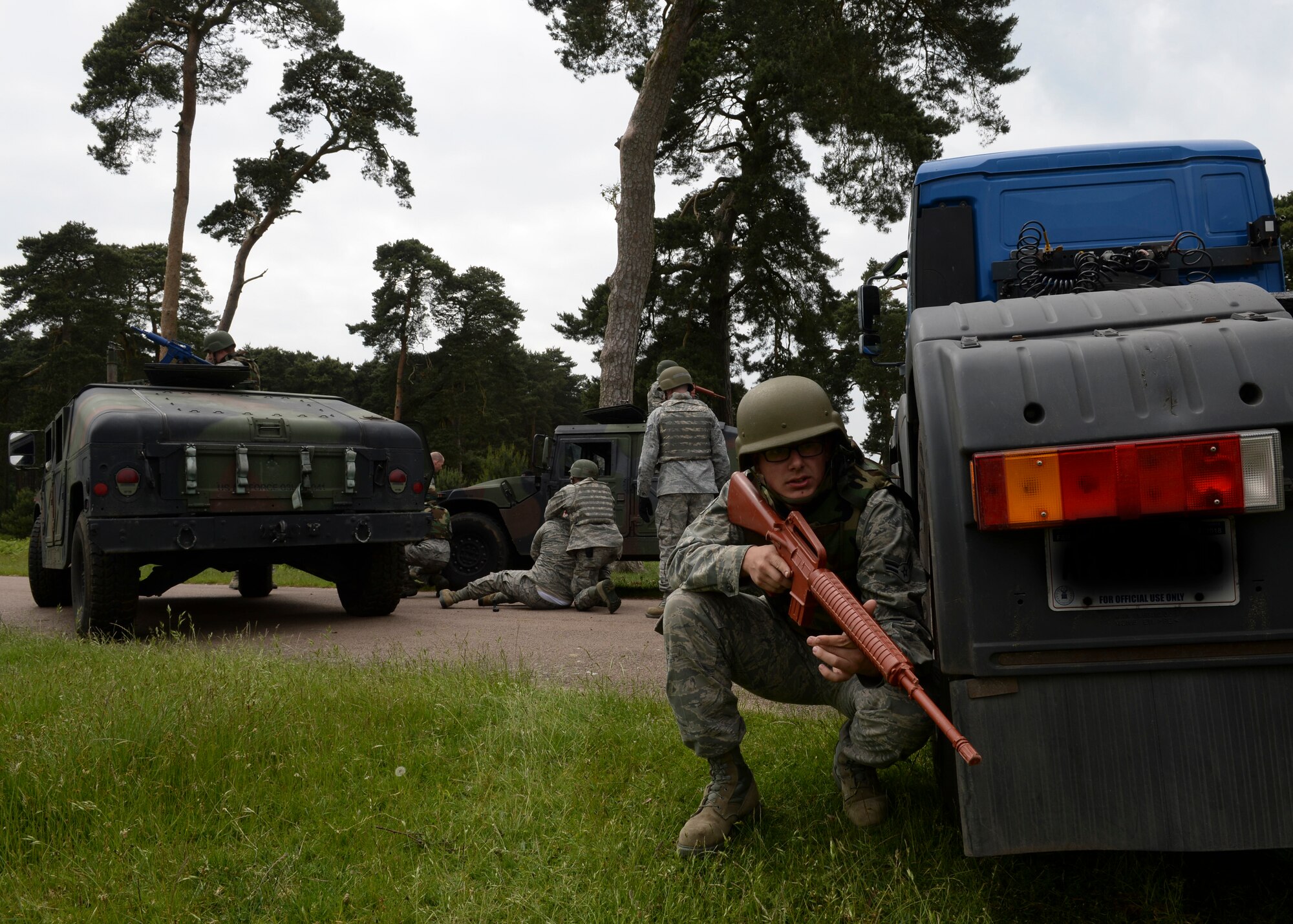 Airman 1st Class Ryan Nyars, 48th Logistics Readiness Squadron vehicle operator, provides security to a convoy formation during Combat Operation Readiness Training at Stanford Training Area, England, May 30, 2014. Vehicles create a box formation to protect simulated injured casualties while medical attention is provided. (U.S. Air Force photo by Airman 1st Nigel Sandridge/Released)