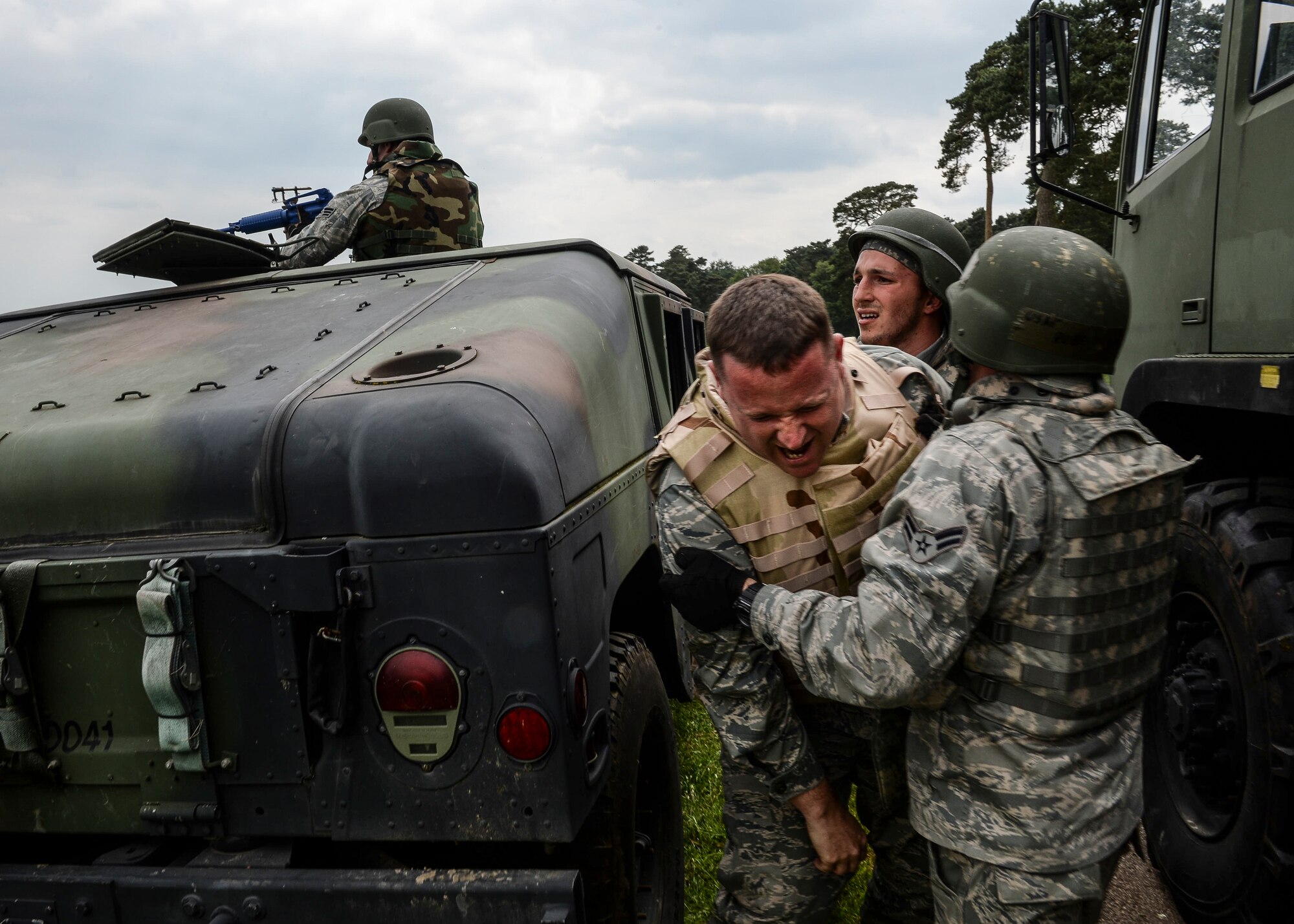 Col. Marc Vandeveer, 48th Mission Support Group commander, simulates a injures during an extraction at Combat Operation Readiness Training at Stanford Training Area, England, May 30, 2014. Extractions are conducted to rescue injured victims and help prevent further potential danger. (U.S. Air Force photo by Airman 1st Nigel Sandridge/Released)