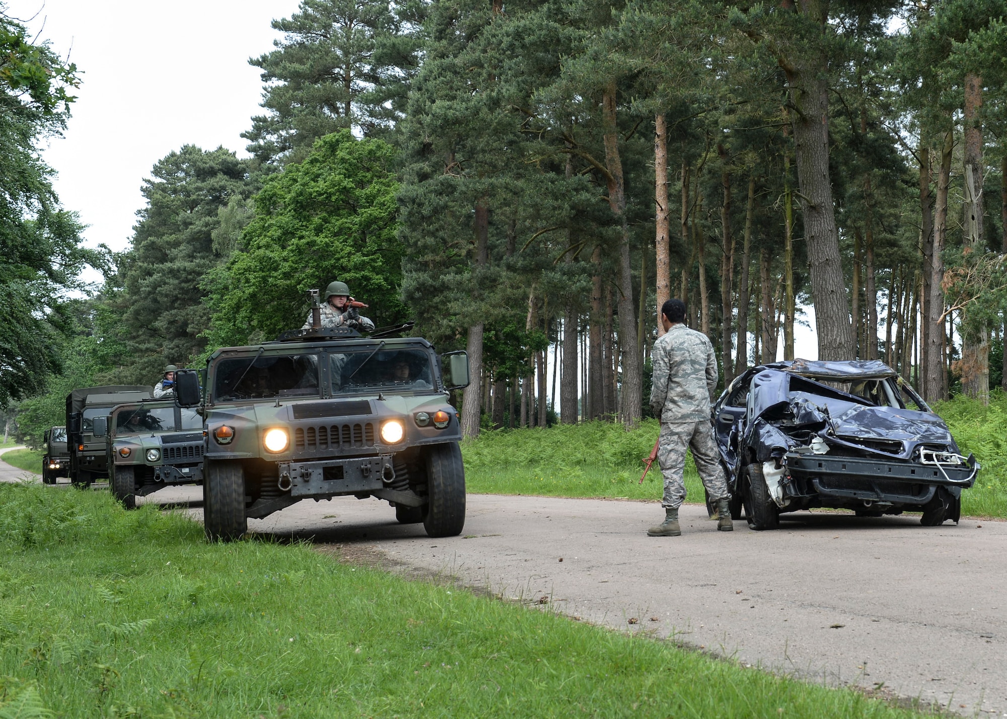 A mock insurgent blocks the road, forcing the convoy to divert at Combat Operation Readiness Training at Stanford Training Area, England, May 30, 2014. U.S. and U.K. armed forces members spent three days undergoing various training exercises from convoy tactical formation and self-aid and buddy care, to explosive device and ordnance detection and avoidance drills. (U.S. Air Force photo by Airman 1st Nigel Sandridge/Released)