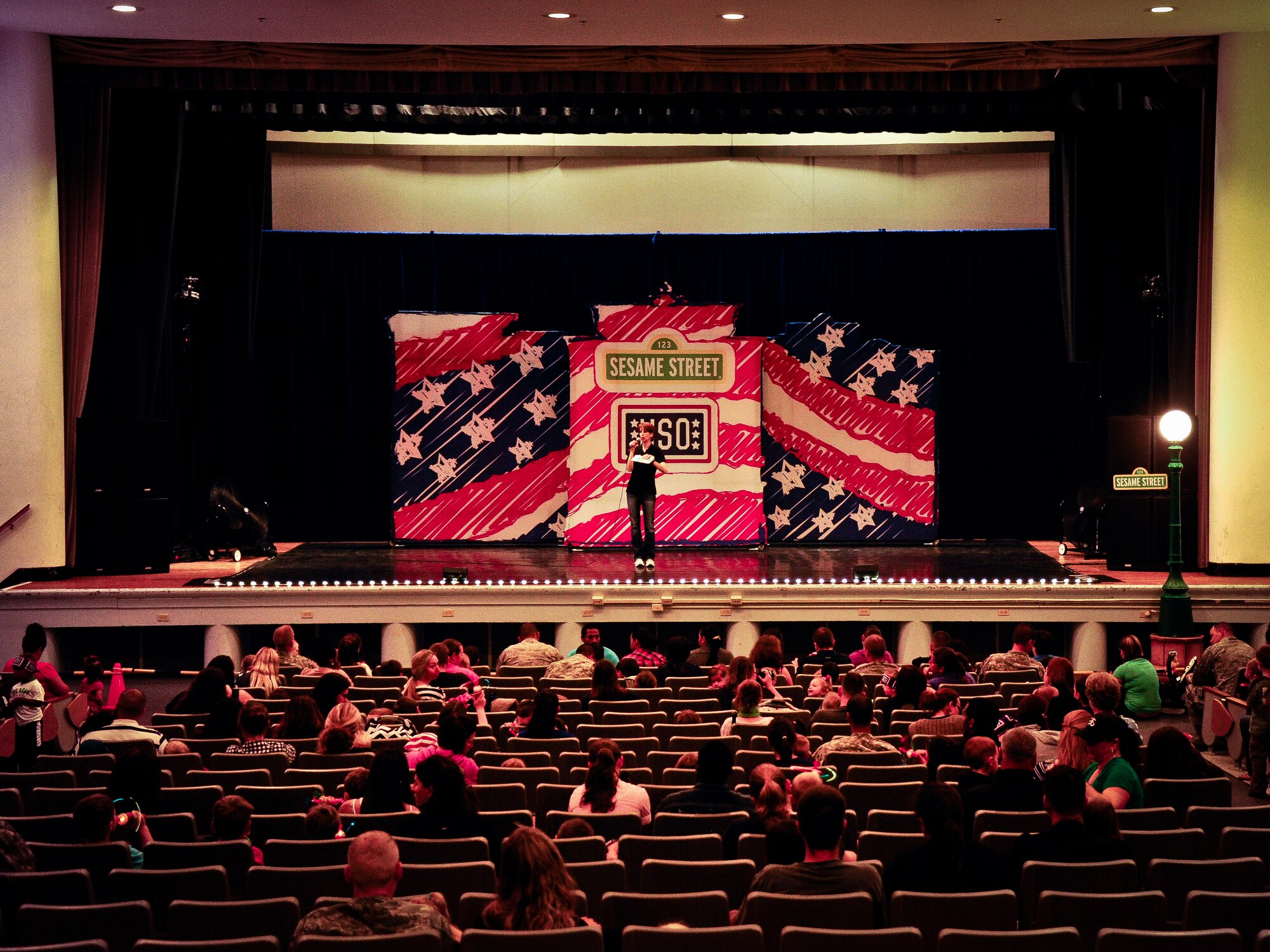 An announcer of the Sesame Street and USO Experience tour welcomes attendees to one of four shows during a two-day period at Joint Base McGuire-Dix-Lakehurst, N.J., May 28, 2014. The show was designed to shine a light on the difficult situations a military child may face while allowing parents the opportunity to address stressful situations that may arise while serving in the armed forces. (U.S. Air Force photo by Staff Sgt. Scott Saldukas/Released)