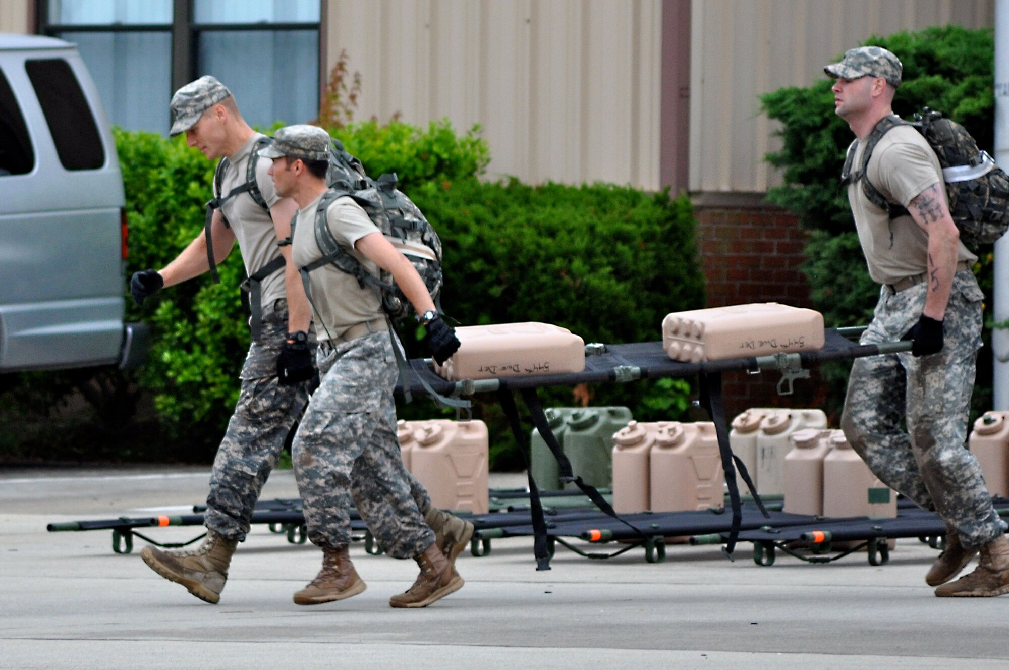 U.S. Army Capt. Richard Miles, 1Lt. Bryce Livingston and Staff Sgt. Shannon Johnson, all from Headquarters and Headquarters Detachment, 10th Transportation Battalion, 7th Transportation Brigade (Expeditionary), start the litter carry that will take them across 3rd Port and over a bridge to the finish line at Rappahannock Annex during the Resolute Warrior Challenge at Fort Eustis, Va., May 30, 2014.  The mile-long litter carry event carried Soldiers through uneven terrain, and was the last event of the challenge. (U.S. Army photo by Sgt. Stefanie Warner/Released) 