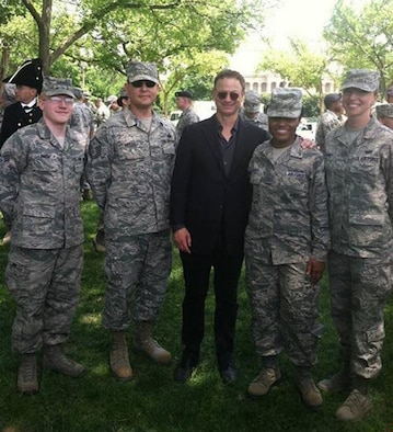 Four Airmen from Headquarters, Air Force Office of Special Investigations, represented OSI in a 140-person Air Force formation that marched in the 10th National Memorial Day Parade, Washington, D.C., May 26, 2014. From left to right are Senior Airman Patrick Smith, Master Sergeant Juan Arispe, Actor Gary Sinise, Senior Airman Latesha Oliver and Technical Sergeant Kelly Lazenby. 
