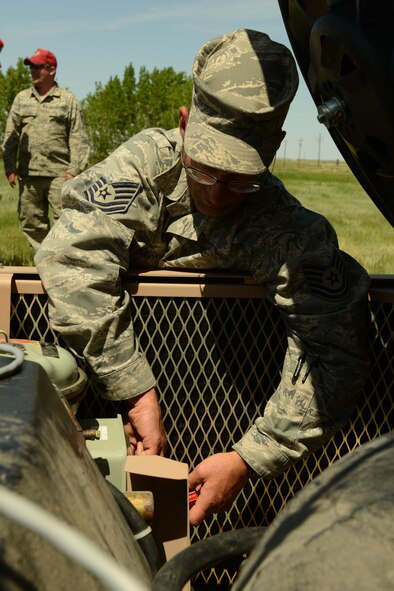 Tech. Sgt. Erich Vankirk, 219th RED HORSE Squadron heating ventilation and air conditioning member, adjusts a cooling fan during a field training exercise at Malmstrom Air Force Base on May 30. More than 100 RED HORSE Airmen honed their skills, as subject-matter experts from the 120th Airlift Wing of the Montana Air National Guard, 341st Civil Engineer Squadron and 819th RED HORSE Squadron provided training instructors. (U.S. Air Force photo/Senior Airman Katrina Heikkinen)