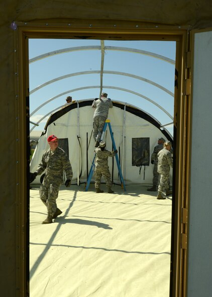 Airmen from the 219th RED HORSE Squadron conference construct a Disaster Relief Bed-down System during a field training exercise at Malmstrom Air Force Base on May 29. DRBD systems have the capability to provide a basic living environment for 150 people and are used during natural disasters. (U.S. Air Force photo/Senior Airman Katrina Heikkinen)