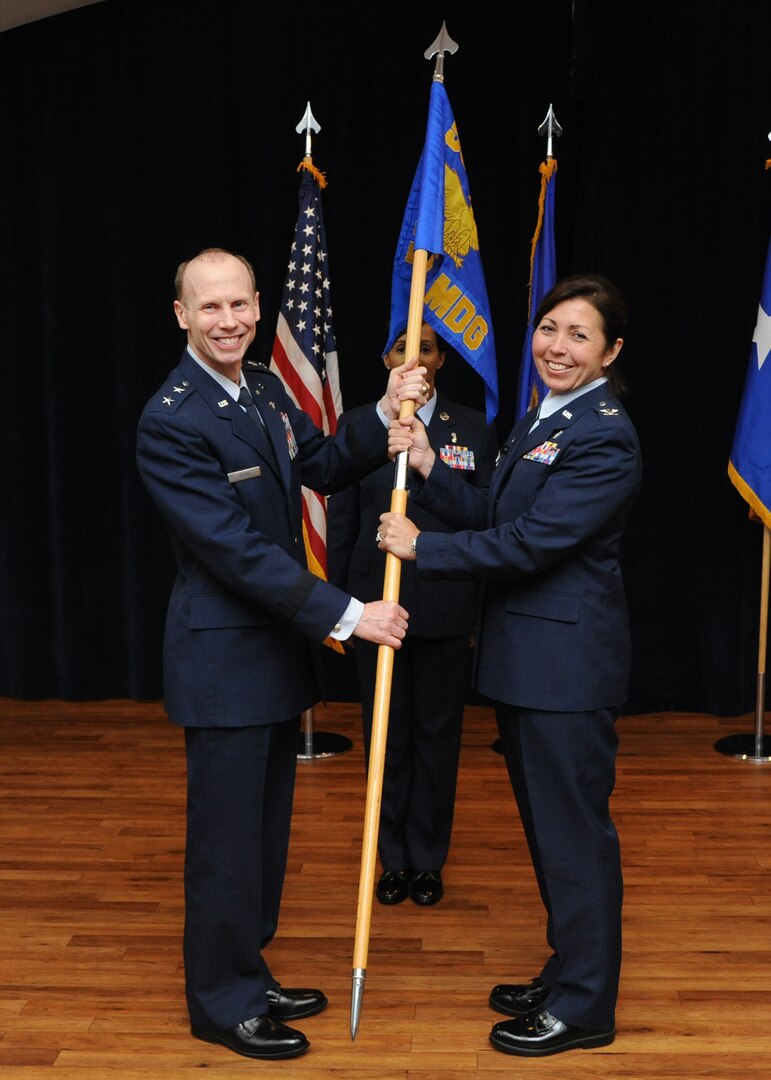 Maj. Gen. Bart O. Iddins, 59th Medical Wing commander, presents the 359th
Medical Group organizational guidon to Col. Dana James, during the unit's
change of command ceremony May 29, 2014 at Joint Base San Antonio-Randolph.
Iddins officiated the ceremony as Col. Althea B. B. Miller relinquished
command of the 359th MDG to James. James, a native of Reading, Pennsylvania,
previously commanded the 60th Medical Operations Squadron, Travis Air Force
Base, California. In 1987, she received her bachelor of science in nursing
from West Chester University, Pennsylvania, and was commissioned in the Air
Force in May 1989. James received her master of education in exercise
science and wellness from Wichita State University, Kansas, in 2001. James
is board-certified in nursing administration and has held various clinical
and administrative positions. (U.S. Air Force photo/Melissa Peterson)