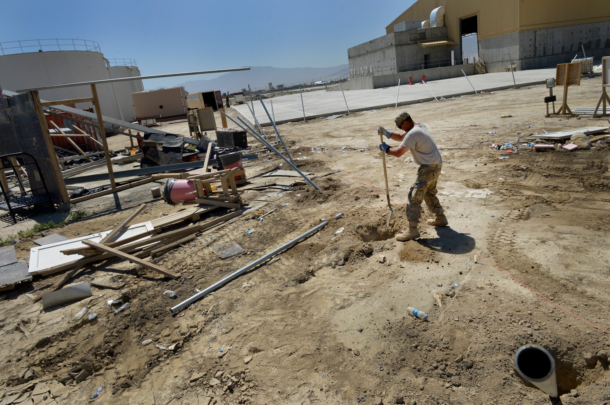 U.S. Air Force Staff Sgt. Jason Ahumada, 577th Expeditionary Prime Base Engineer Emergency Force Squadron engineering craftsman digs a hole for a new security fence at Bagram Airfield, Afghanistan May 24, 2014.  The 577th EPBS is forward deployed from the 1st Expeditionary Civil Engineer Group at Al Udeid Air Base, Qatar. The squadron’s missions are light troop construction, assessments and repairs on assigned missions. Ahumada is deployed from Nellis Air Force Base, Nev. and a native of Cottonwood, Ariz. (U.S. Air Force photo by Staff Sgt. Evelyn Chavez)