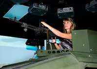 Shelley Kaiser readies her Humvee’s turret-mounted M-240 as she scans for enemy combatants inside the convoy simulator at Naval Construction Training Center Gulfport, Mississippi. The NCTC visit supplemented the tour for a group of Northwest Florida civic leaders to the Air Force Reserve’s 403rd Wing at Keesler Air Force Base, Mississippi. Each year, the 919th Special Operations Wing invites local civic leaders on a tour of other Air Force Reserve units to increase their understanding of the diverse missions accomplished by the Reserve and other Department of Defense organizations.  (U.S. Air Force photo/Tech. Sgt. Jasmin Taylor)