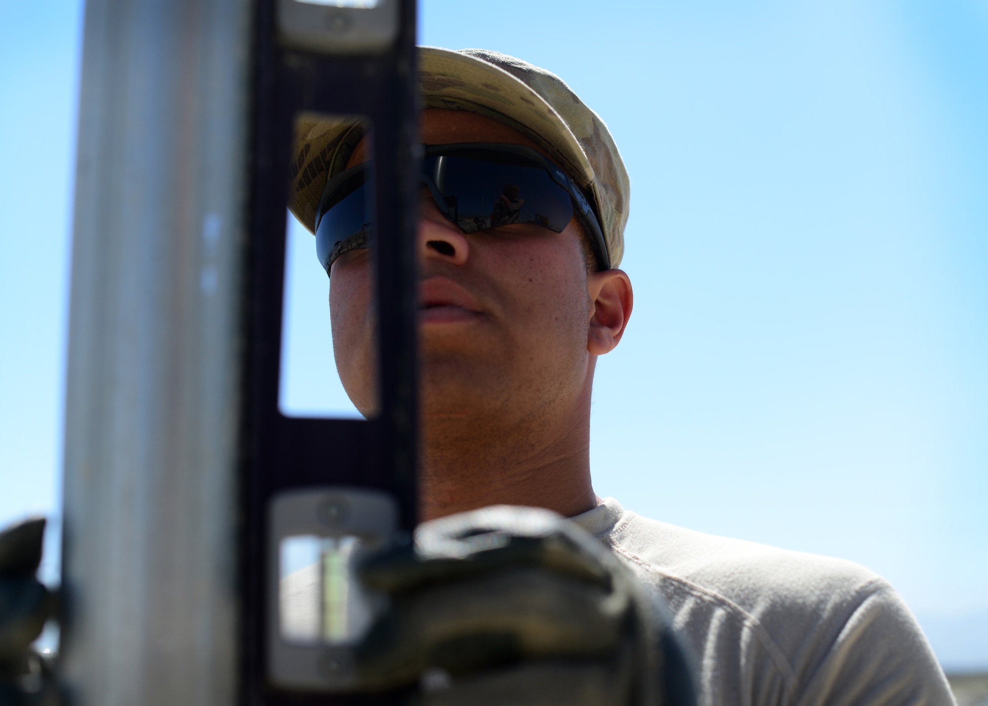 U.S. Air Force Airman 1st Class Patrick Henry Alexander, 577th Expeditionary Prime Base Engineer Emergency Force Squadron troop constructions, levels a pole for a new airfield security fence at Bagram Airfield, Afghanistan May 24, 2014.  The 577th EPBS brings together civil engineering Airmen from across several specialties to perform forward deployed construction work. Henry Alexander is deployed from Davis Monthan, Ariz. and a native of Gainesville, Fla. (U.S. Air Force photo by Staff Sgt. Evelyn Chavez)