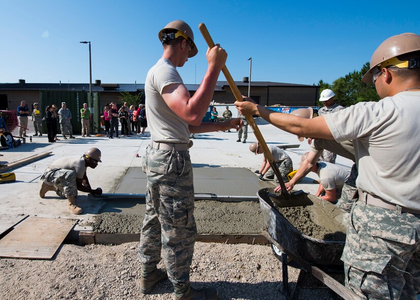 Northwest Florida civic leaders observe trainees constructing a concrete pad at Naval Construction Training Center Gulfport, Mississippi.  The NCTC visit supplemented the tour for a group of Northwest Florida civic leaders to the Air Force Reserve’s 403rd Wing at Keesler Air Force Base, Mississippi. Each year, the 919th Special Operations Wing invites local civic leaders on a tour of other Air Force Reserve units to increase their understanding of the diverse missions accomplished by the Reserve and other Department of Defense organizations.  (U.S. Air Force photo/Tech. Sgt. Jasmin Taylor)
