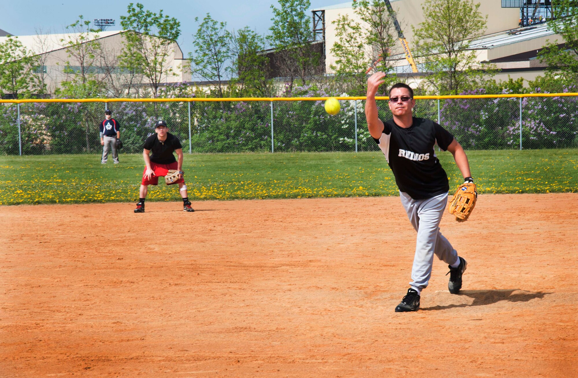 A pitcher lobs a softball during the National Police Week softball tournament May 31, 2014, at Minot Air Force Base, N.D. The tournament hosted members of both military and community law enforcement, and was meant to strengthen the bond between those who serve. (U.S. Air Force photo/Airman 1st Class Lauren Pitts) 