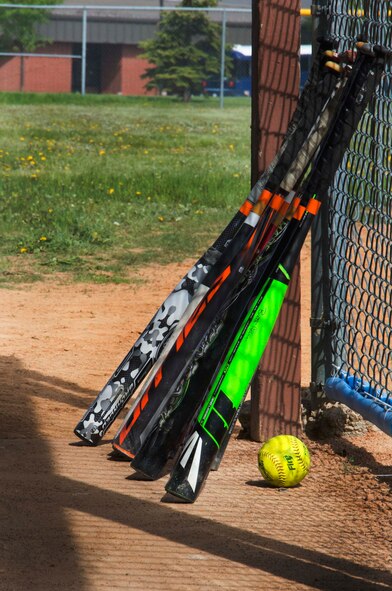Bats lay against a dugout fence during the National Police Week softball tournament at Minot Air Force Base, N.D., on May 31, 2014. The teams consisted of law enforcement members from both the base and local community. (U.S. Air Force photo/Airman 1st Class Lauren Pitts) 