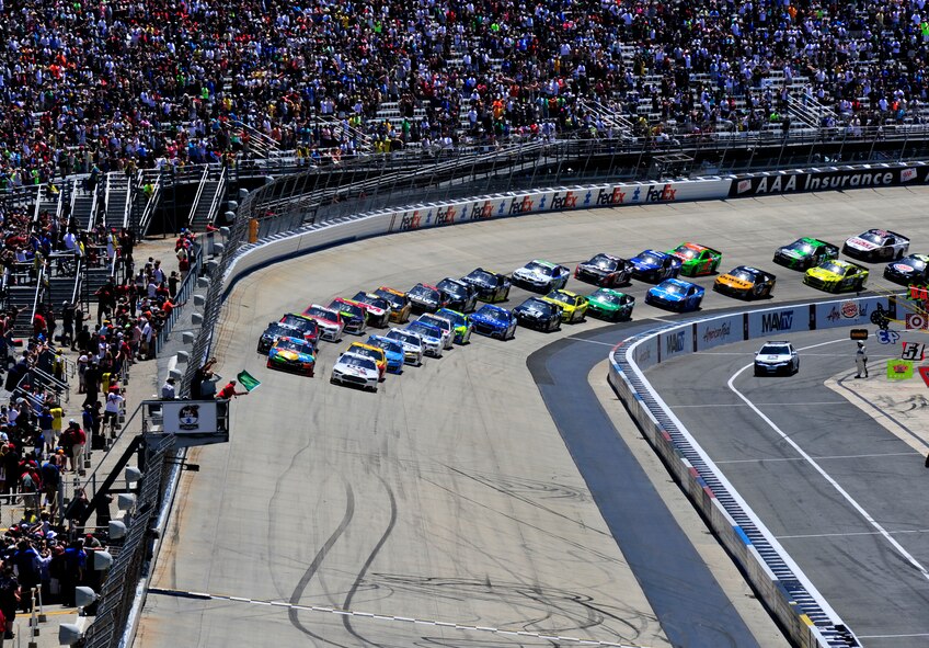 The green flag marking the start of the NASCAR Sprint Series FedEx 400 waves as cars pick up speed prior to crossing the checkered line June 1, 2014 at Dover International Speedway, Dover, Del. Jimmie Johnson, driver of the No. 48 Kobalt Chevy, won at Dover for a record-breaking ninth time. (U.S. Air Force photo/Staff Sgt. Elizabeth Morris)