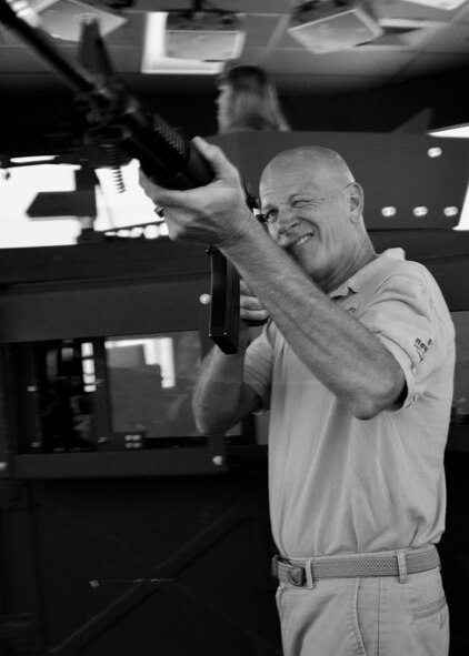 Lynn Dominique takes aim with his M-16 to engage an enemy combatant inside the convoy simulator at the Naval Construction Training Center Gulfport, Mississippi.  The NCTC visit supplemented the tour for a group of Northwest Florida civic leaders to the Air Force Reserve’s 403rd Wing at Keesler Air Force Base, Mississippi.  Each year, the 919th Special Operations Wing invites local civic leaders on a tour of other Air Force Reserve units to increase their understanding of the diverse missions accomplished by the Reserve and other Department of Defense organizations.  (U.S. Air Force photo/Tech. Sgt. Cheryl Foster)