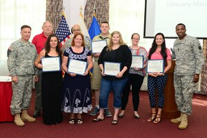 Far left, U.S Army Col. William Galbraith, 733rd Mission Support Group commander hosted a Volunteer of the Quarter ceremony at Fort Eustis, Va., May 28, 2014. Nine members from multiple organizations were honored during the ceremony. (U.S. Air Force photo by Airman 1st Class Kimberly Nagle/Released)