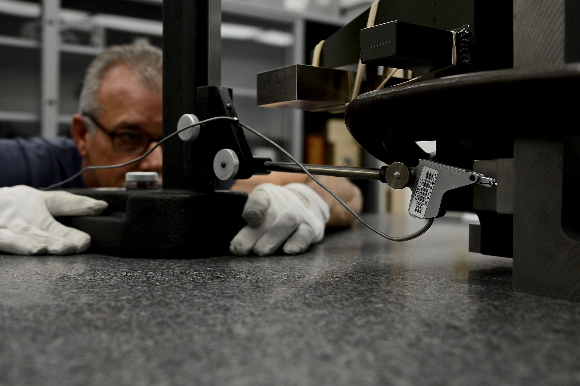 Dave McGranahan, 6th Maintenance Squadron precision measurement equipment laboratory technician, checks the parallelism of mounting pins on a vector radar boresight fixture Q2 May 27, 2014, MacDill Air Force Base, Fla. McGranahan, a Riverview, Fla., native, has worked PMEL for more than 30 years between his time on active duty and as a civilian. (U.S. Air Force photo by Airman 1st Class Ned T. Johnston/Released) 