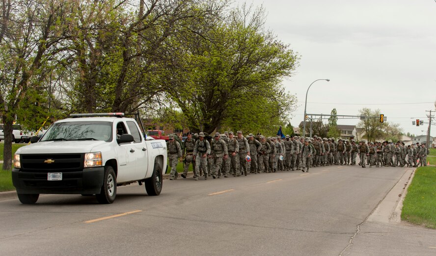 Members of 5th Bomb Wing and 91st Missile Wing Security Forces Squadrons, the office of special investigations, the MAFB K-9 unit and members of the National Guard and reserve participate in a ruck march in honor of National Police Week at Minot Air Force Base, N.D., May 27, 2014. The event was open to everyone who brought their own rucksack or backpack for the march with a military standard weight of 35 pounds. (U.S. Air Force photo/Senior Airman Stephanie Morris)