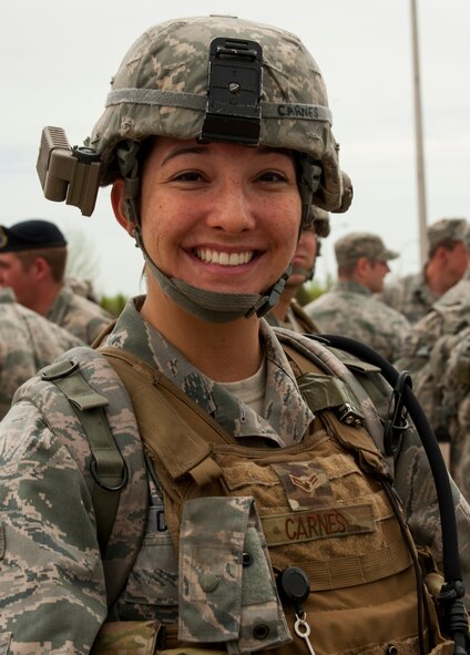 Senior Airman Nicole Carnes, 91st Missile Security Forces Squadron response force leader, smiles while standing with a group of her peers before a ruck march in honor of National Police Week at Minot Air Force Base, N.D., May 27, 2014. The event was open to everyone who brought their own rucksack or backpack for the march with a military standard weight of 35 pounds. (U.S. Air Force photo/Senior Airman Stephanie Morris)
